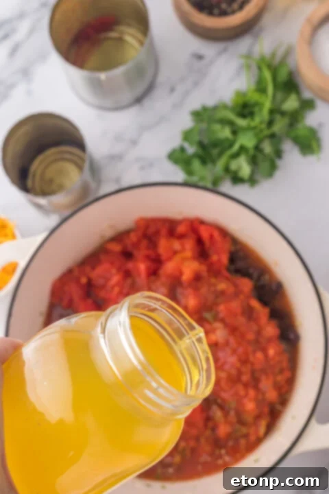 Close-up of chicken taco soup simmering, highlighting the rich broth and spices.