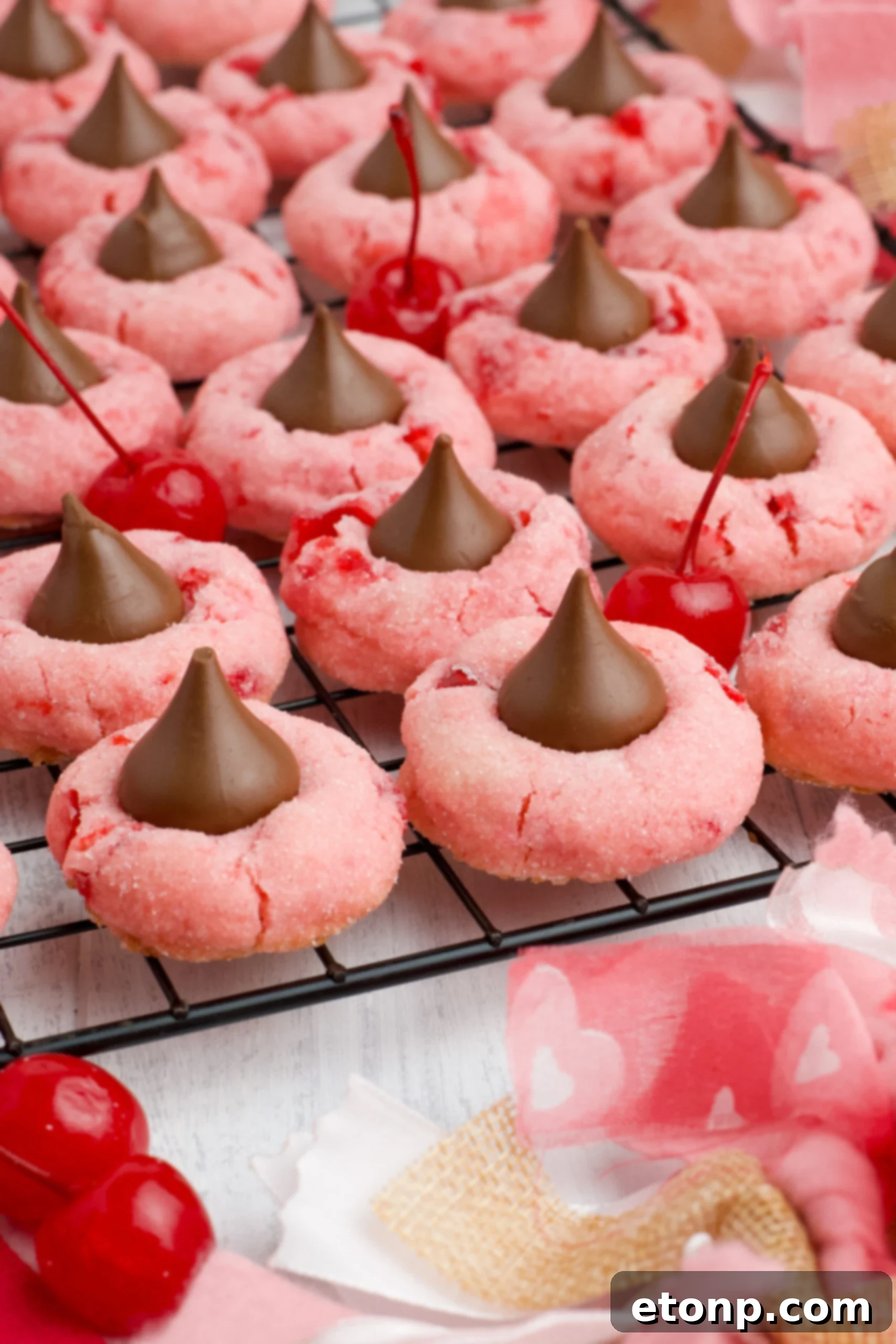 Front view of Cherry Blossom Cookies neatly arranged on a black wire rack, showcasing a full batch ready for enjoyment.