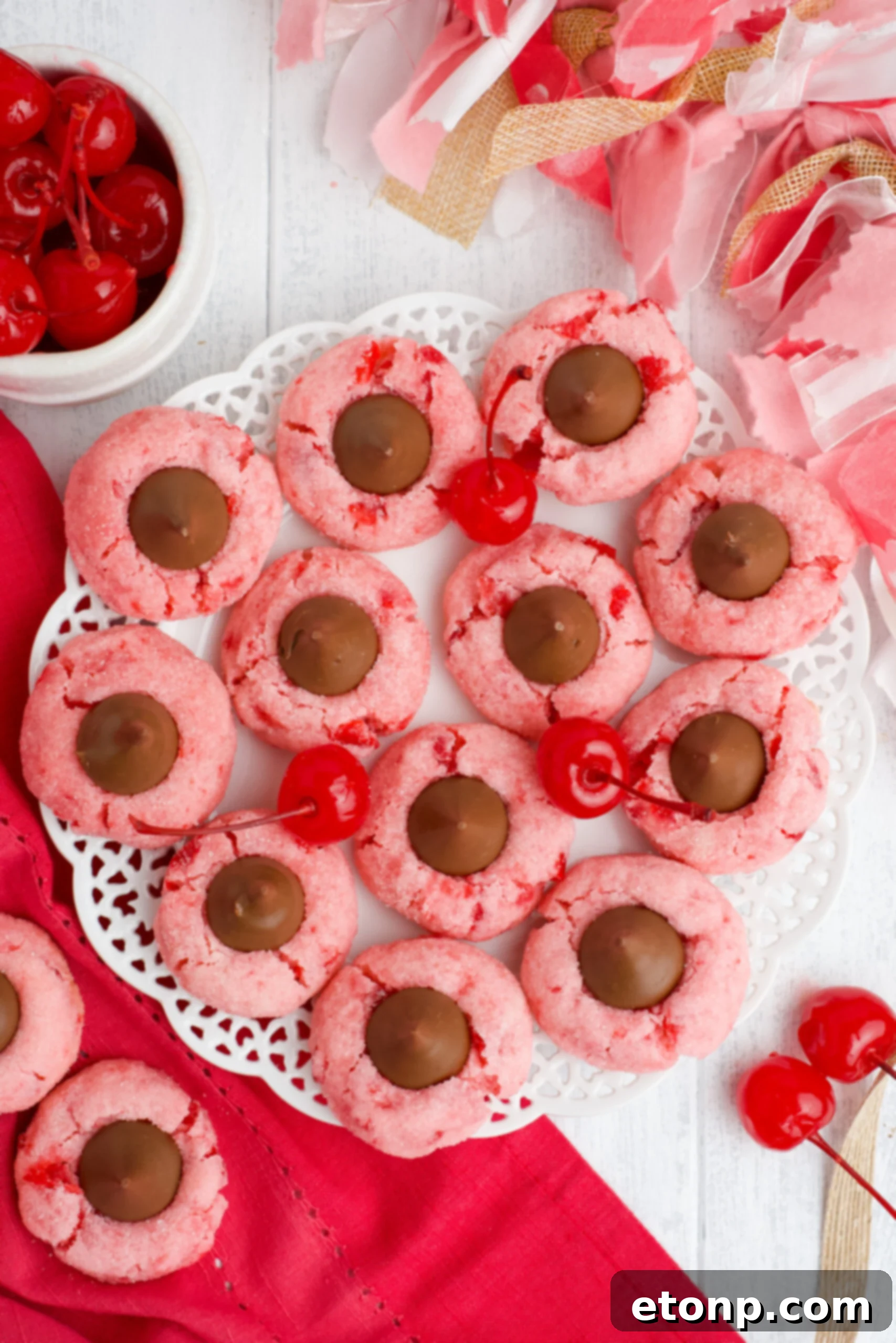 Overhead view of several Cherry Blossom Cookies artistically arranged on a white dish, highlighting their uniform shape and appealing presentation.