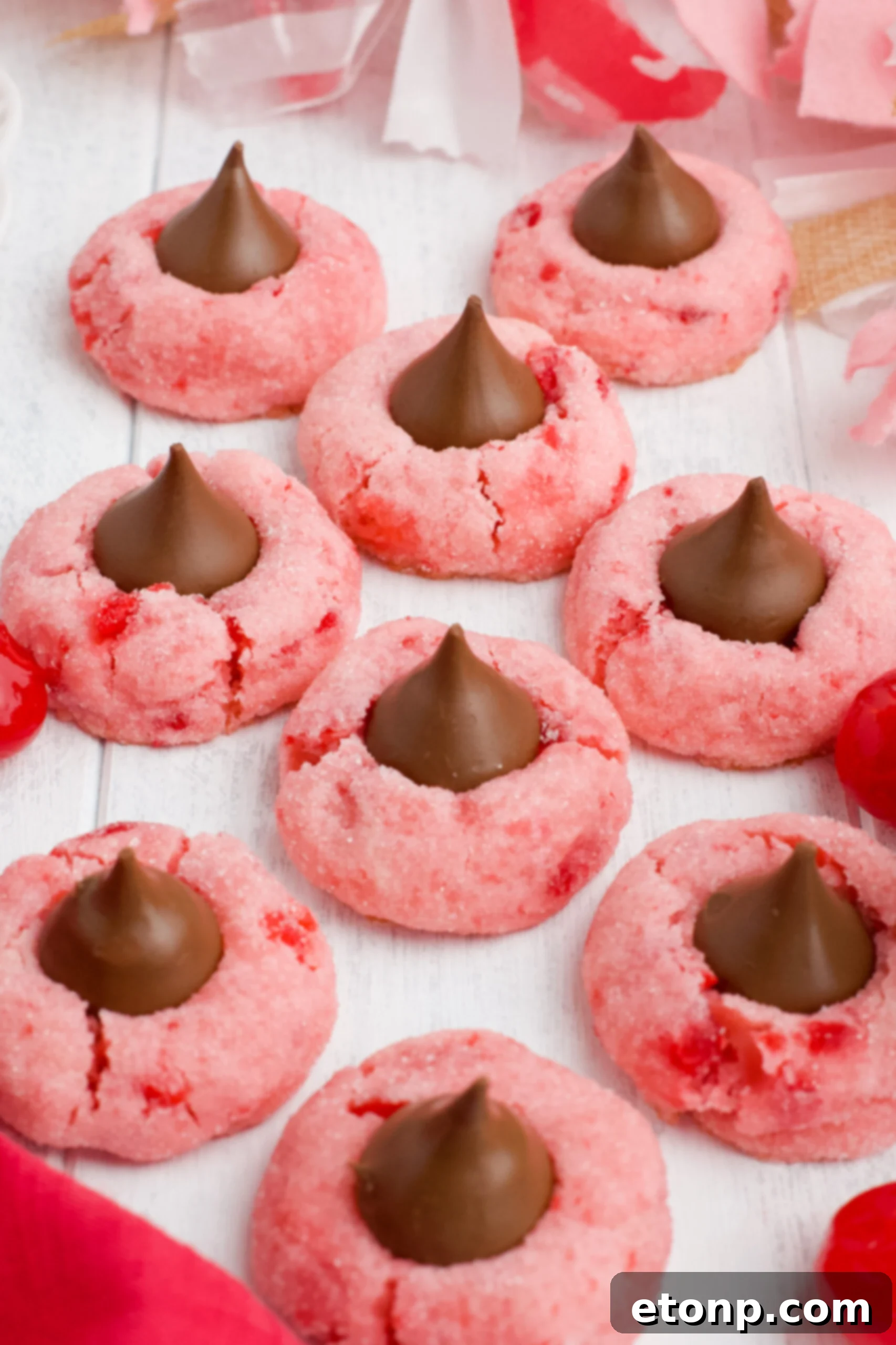 A front view of Cherry Blossom Cookies, perfectly round with a distinct chocolate kiss in the middle.