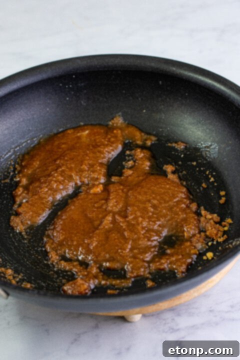 Cracker Barrel Fried Apples presented in a bowl, showing the tender apple slices coated in a glossy, spiced sauce.
