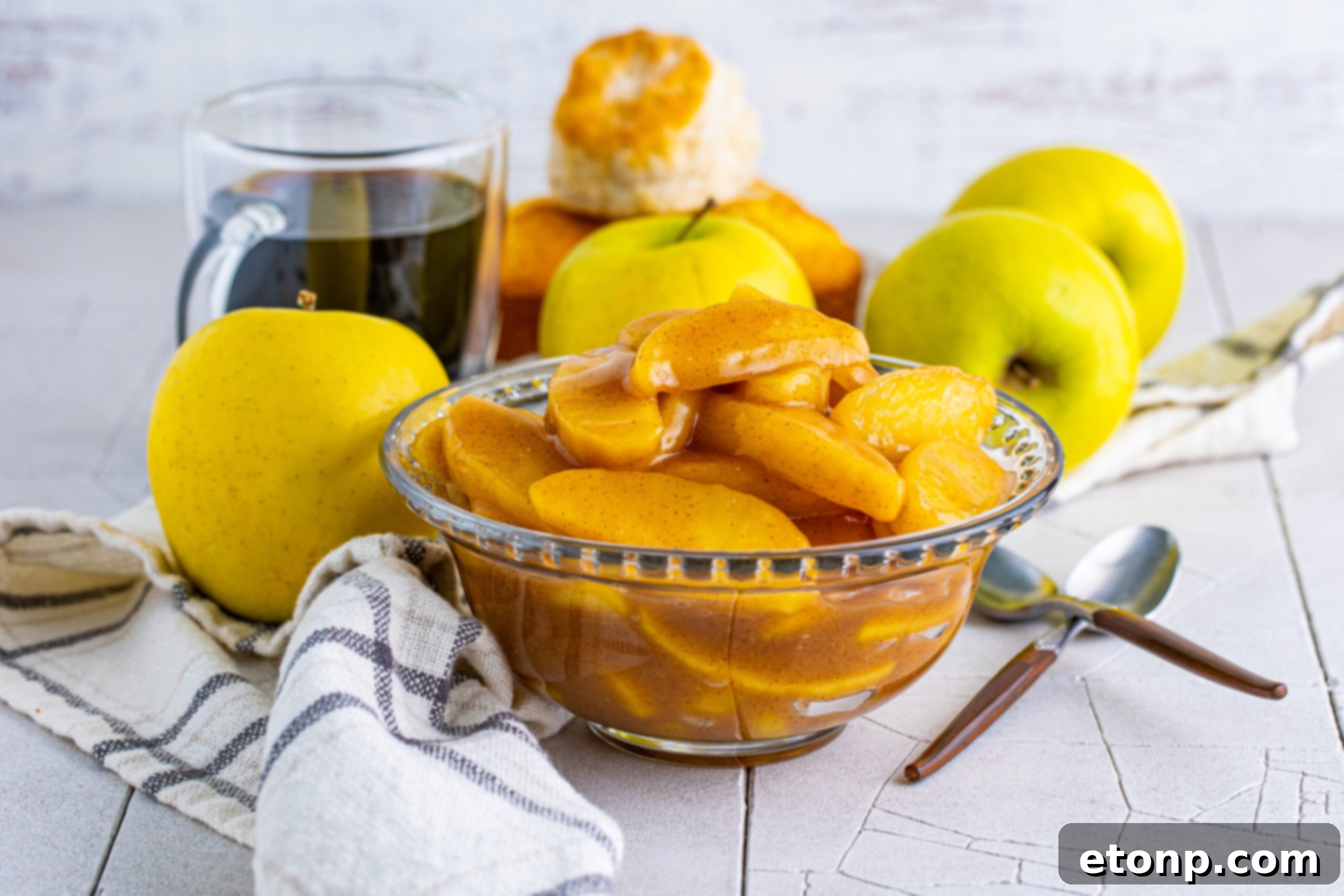 Front view of Cracker Barrel Fried Apples in a clear glass bowl, showcasing their delicious glaze and inviting aroma.
