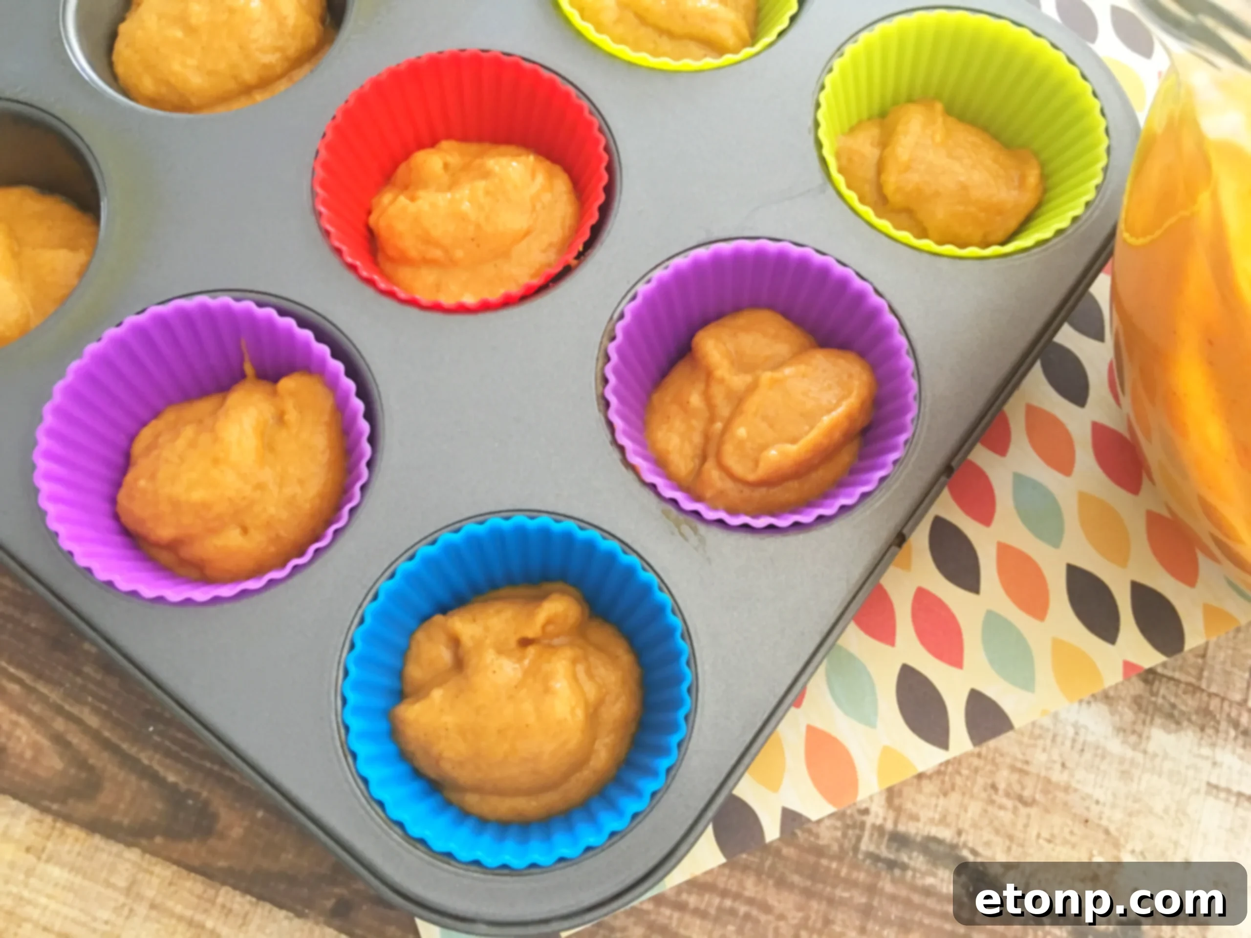 A vibrant batch of pumpkin cupcakes cooling, emitting a wonderful aroma.
