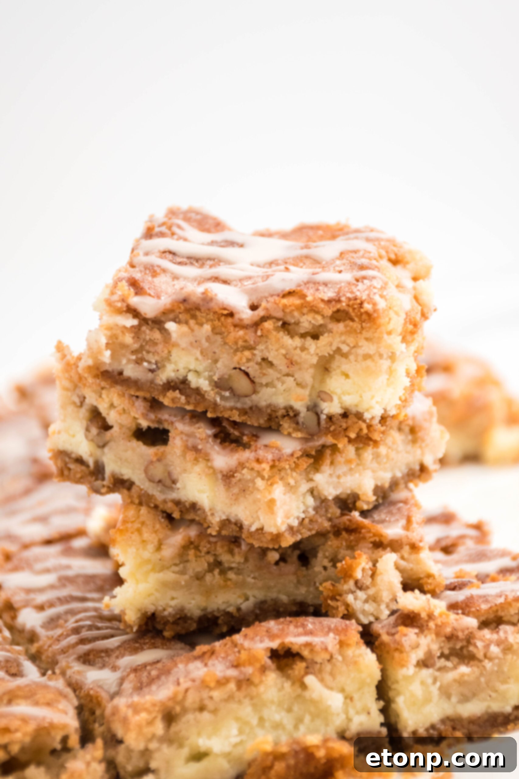 Front view of three Snickerdoodle Cheesecake Bars stacked.