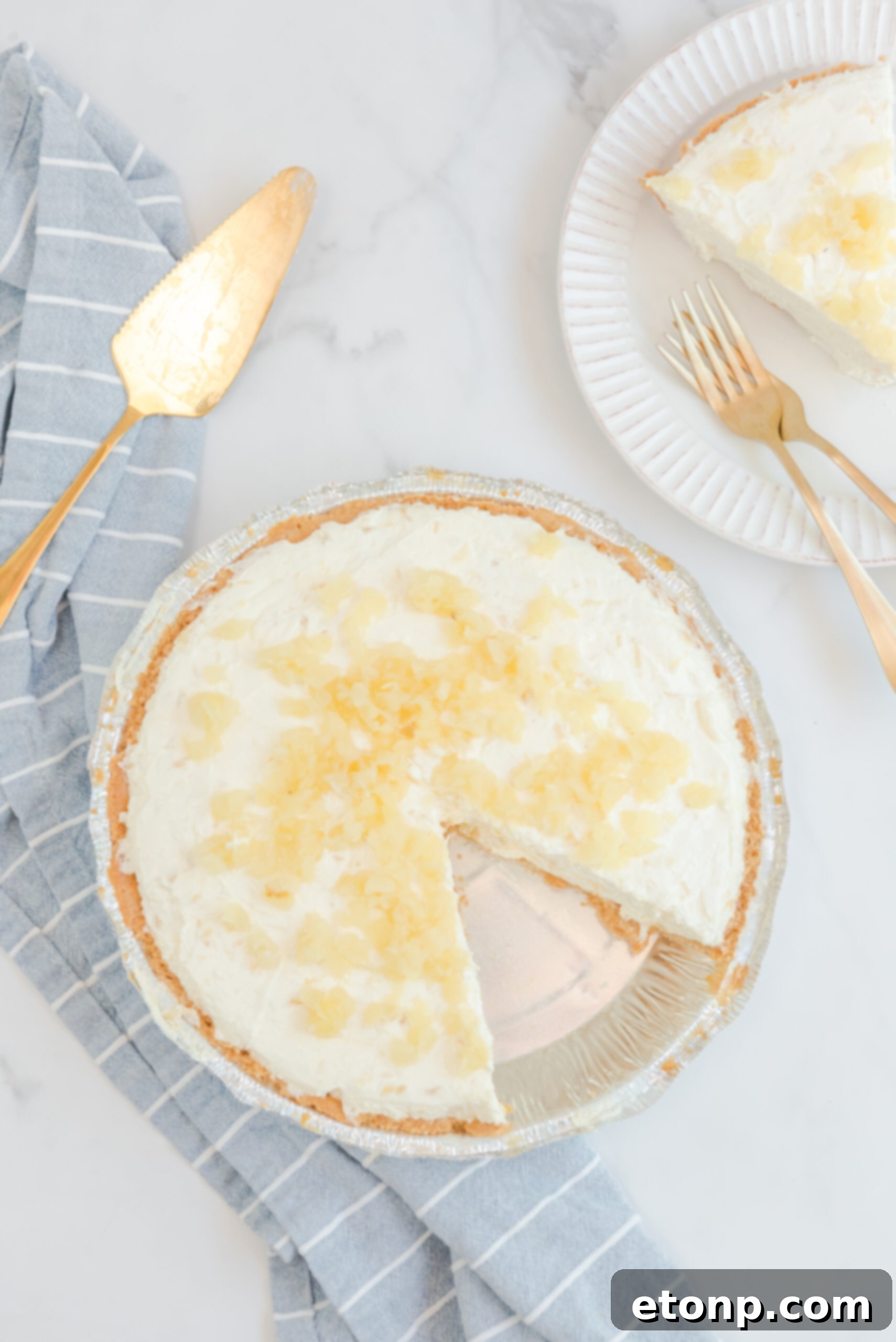 Chilled Pineapple Cheesecake Bliss 7 Overhead view of No Bake Pineapple Cheesecake with a slice removed.