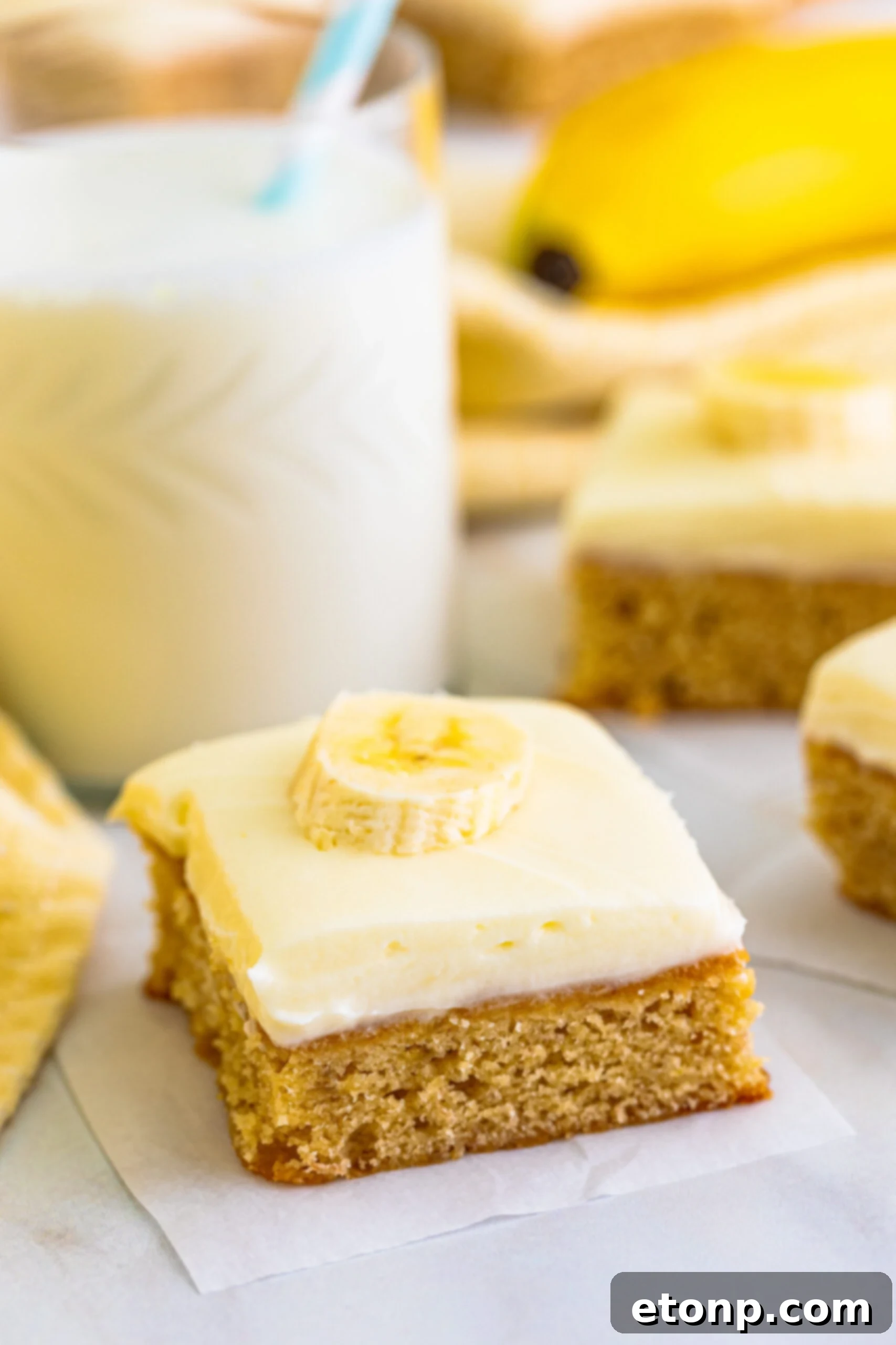 Ultimate Banana Brownies 2 Close up view of Banana Brownies on parchment paper, showing their moist texture.