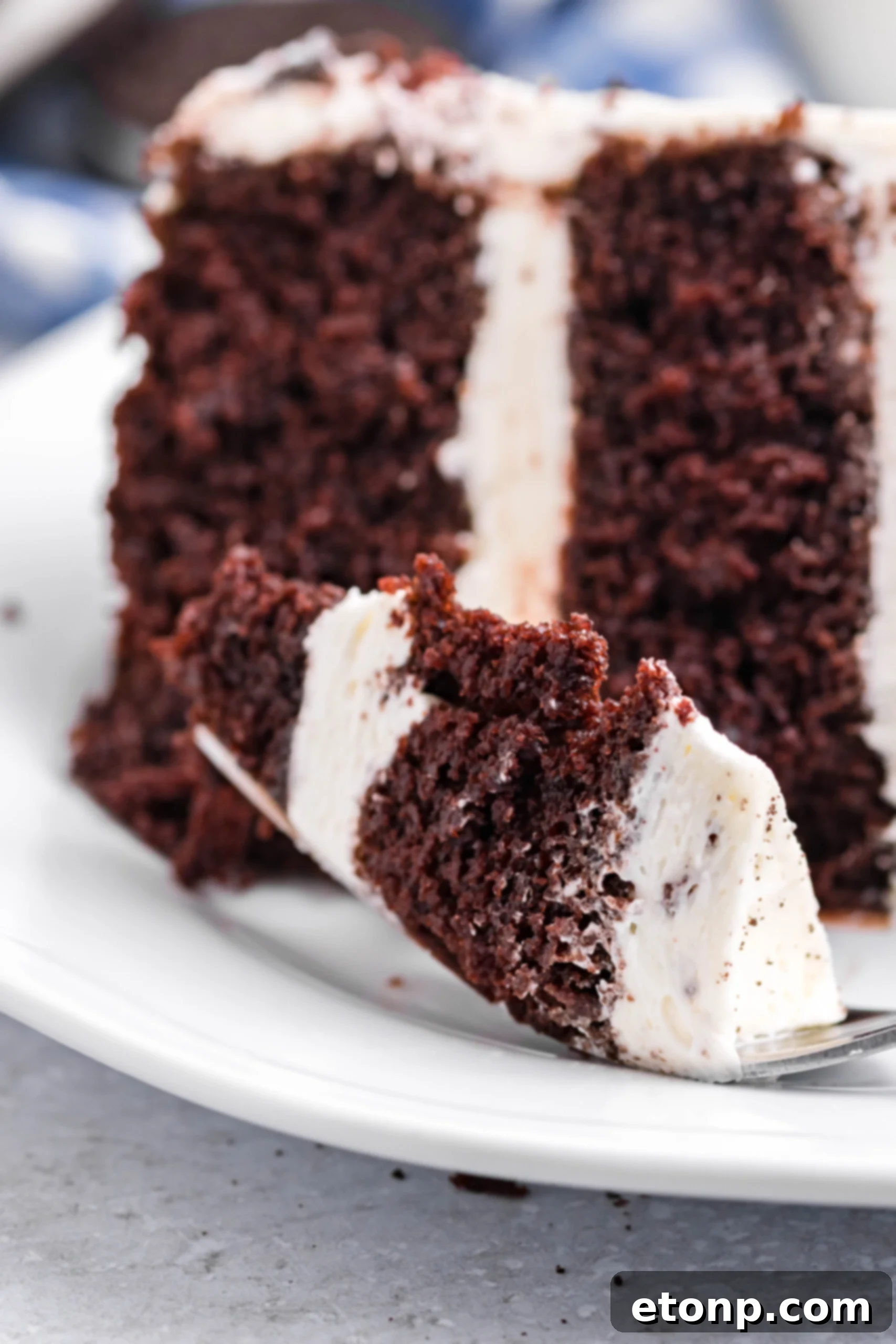 A bite of Double Stuffed Oreo Cake on a silver fork.