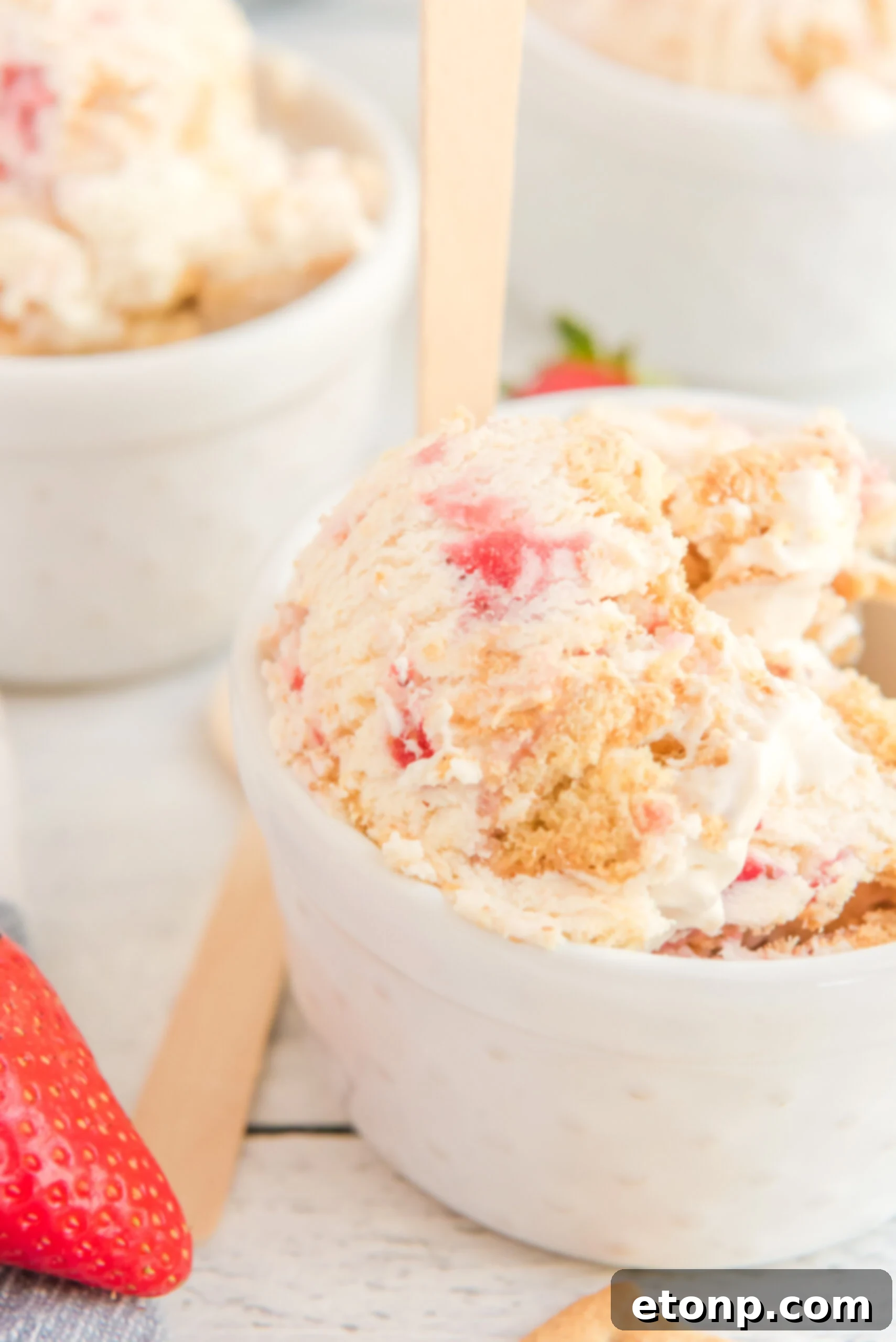 white bowl filled with Strawberry Cheesecake Ice Cream.