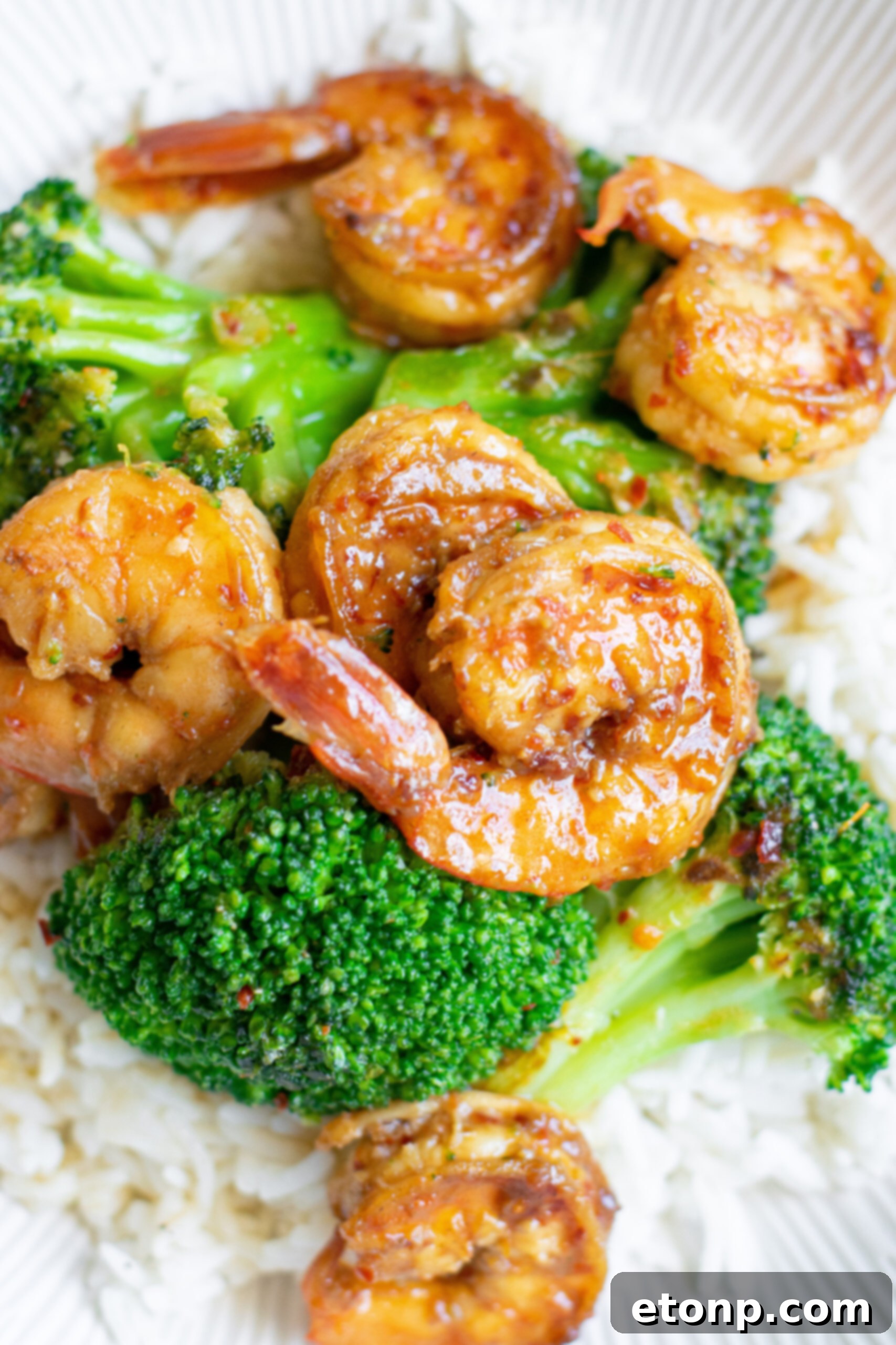 Garlic Shrimp and Broccoli Skillet 8 Close up view of the shrimp and broccoli plated over rice.
