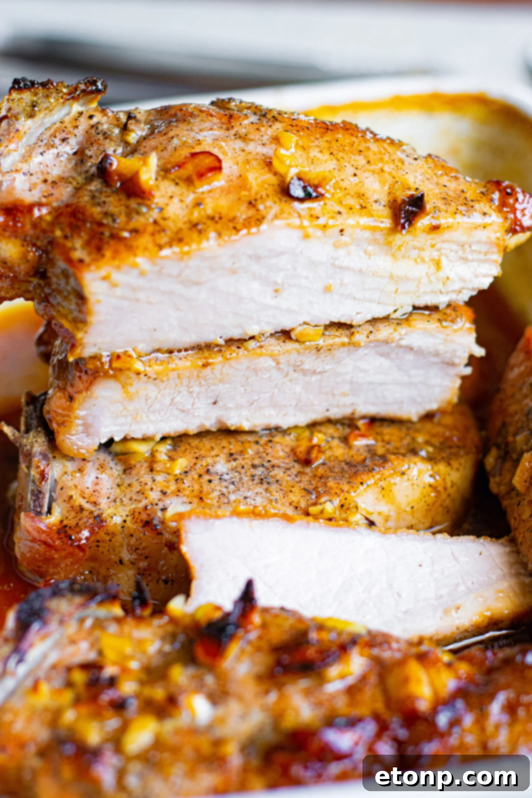 A beautifully cooked Honey Garlic Pork Chop, glistening with sauce.