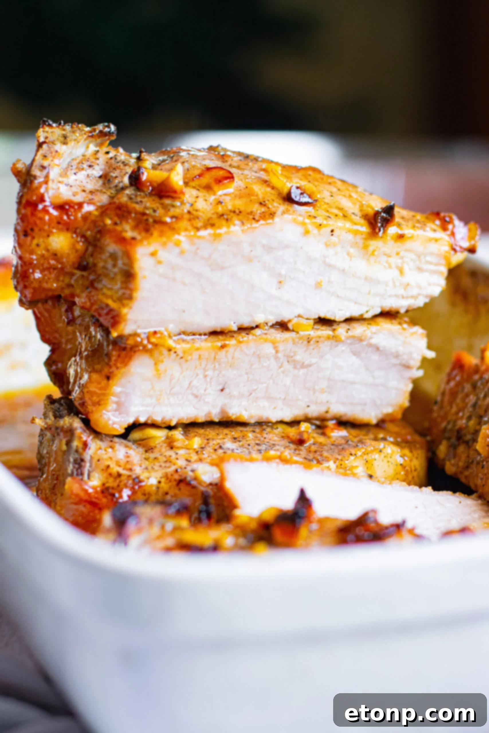 Front view of Honey Garlic Pork Chops halved and stacked, ready to be served.