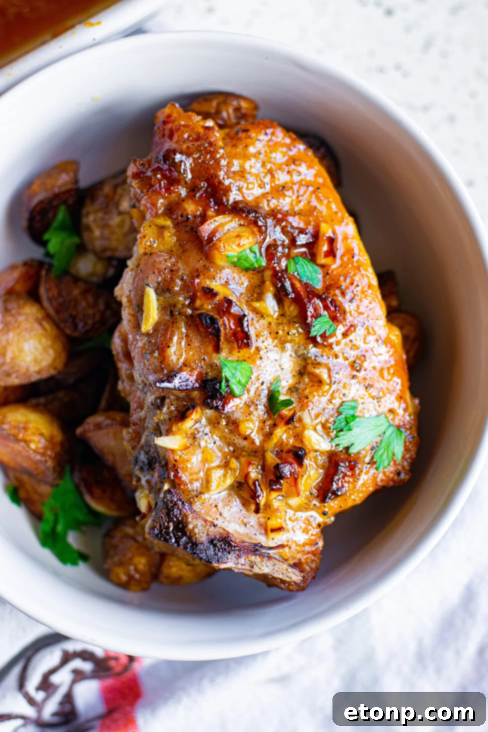 Overhead view of Honey Garlic Pork Chops served over potatoes, showcasing a complete meal.