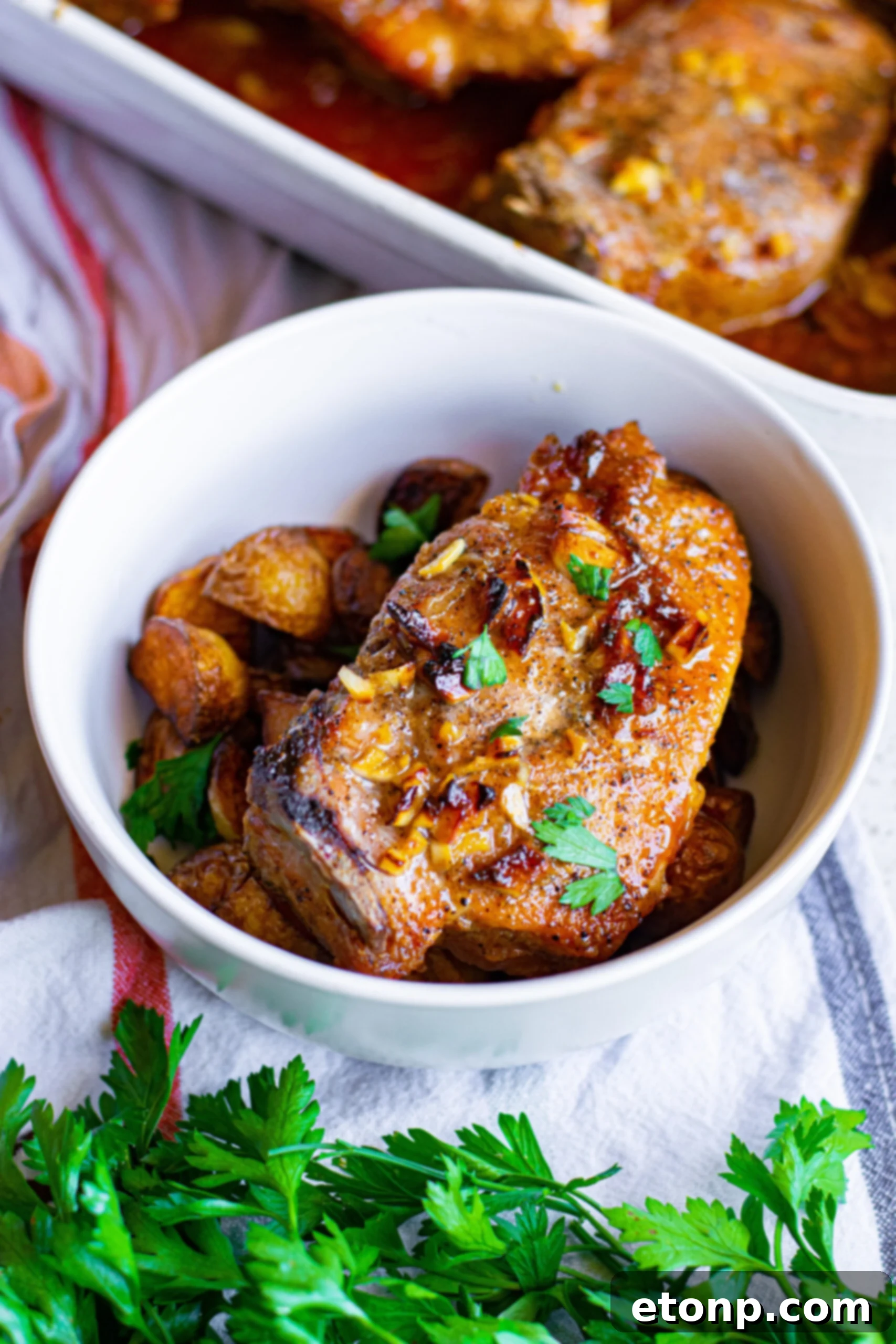 Overhead view of Honey Garlic Pork Chops served over potatoes, presented as a hearty meal.