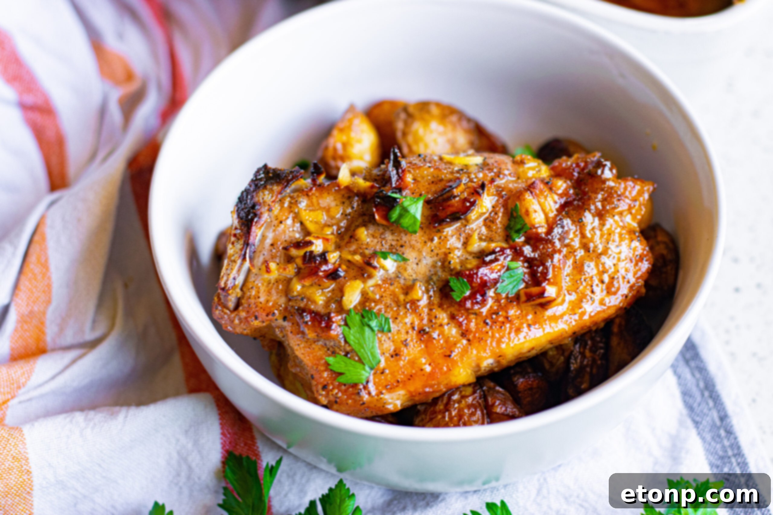 Overhead view of Honey Garlic Pork Chops served over potatoes, highlighting the golden-brown color.