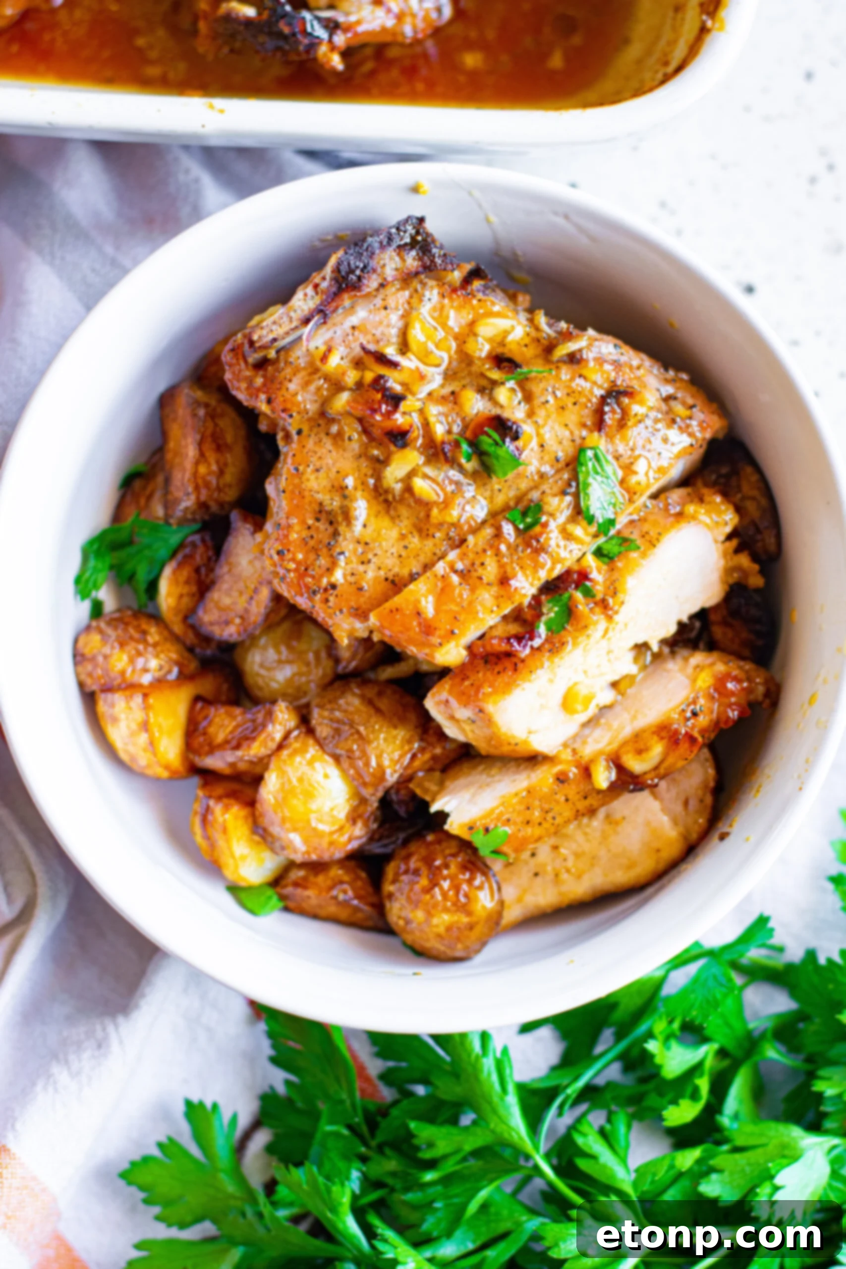 Overhead view of Honey Garlic Pork Chops cut into strips and served over potatoes, ready to eat.