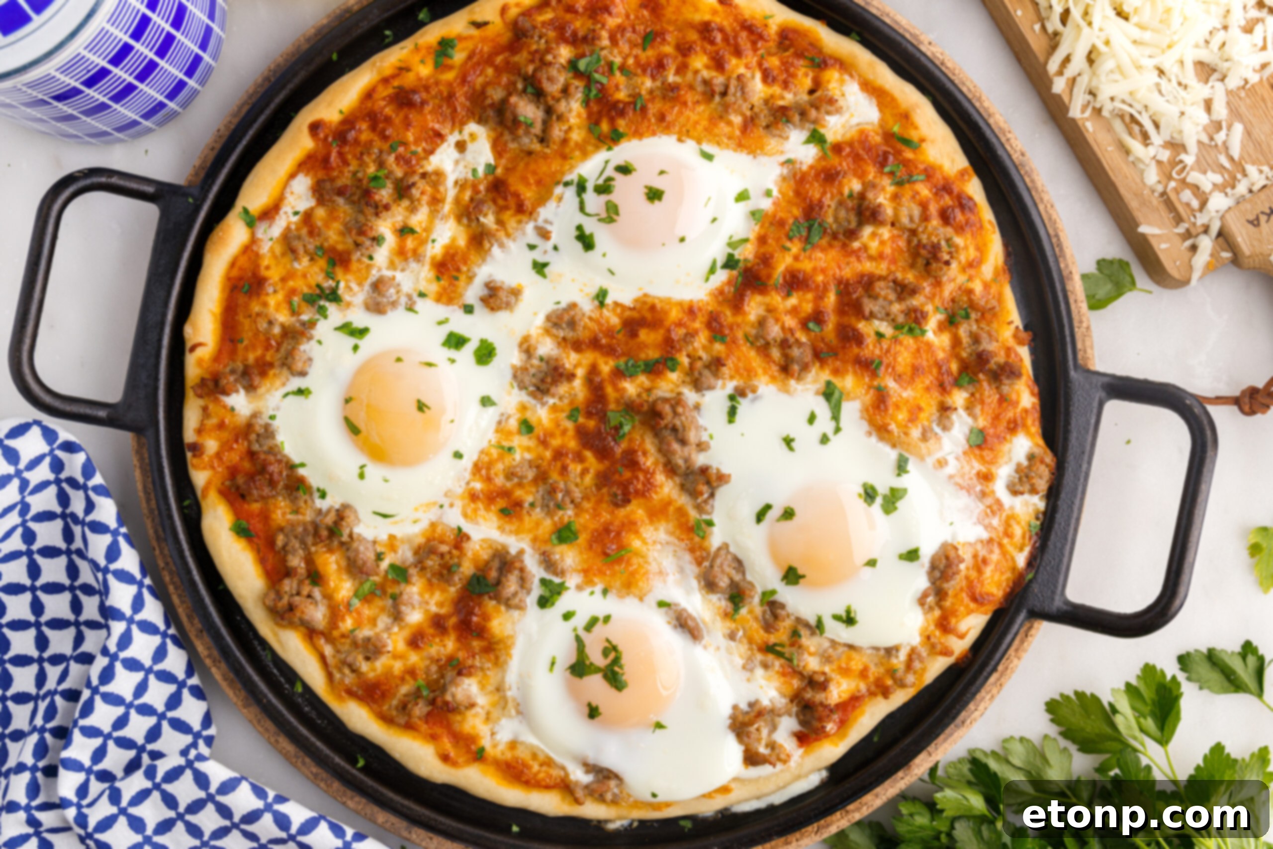 Overhead view of Breakfast Pizza on a black pizza dish.