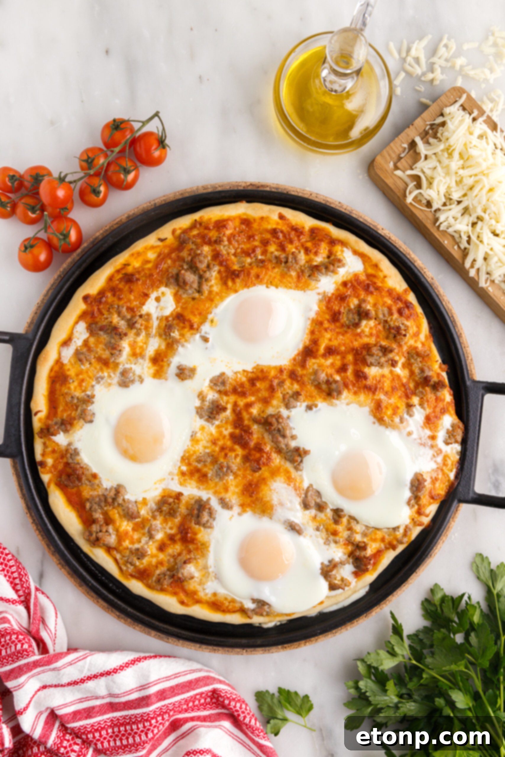 Overhead view of Breakfast Pizza on a black pizza dish.