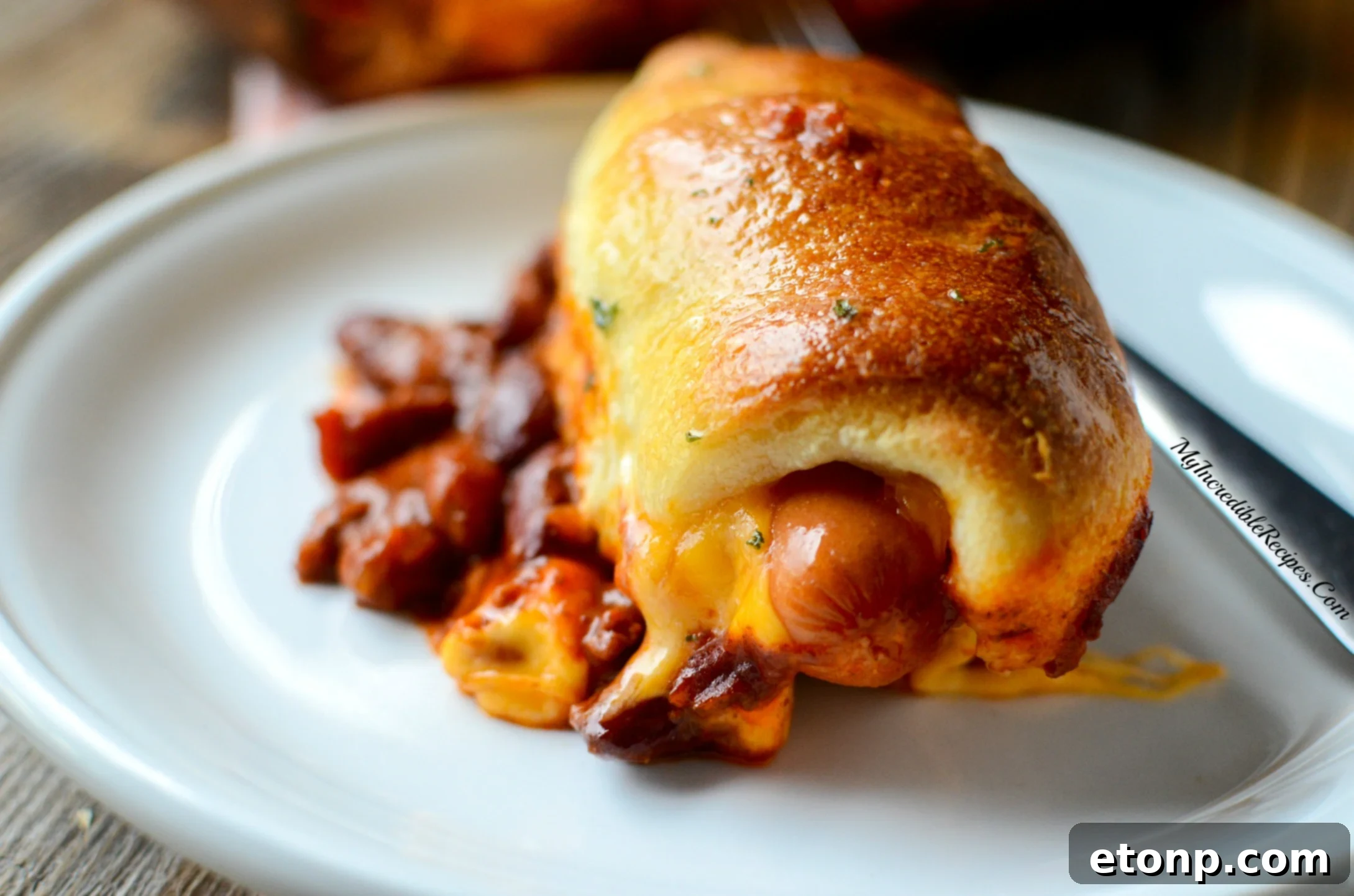 Two chili cheese dogs with toppings