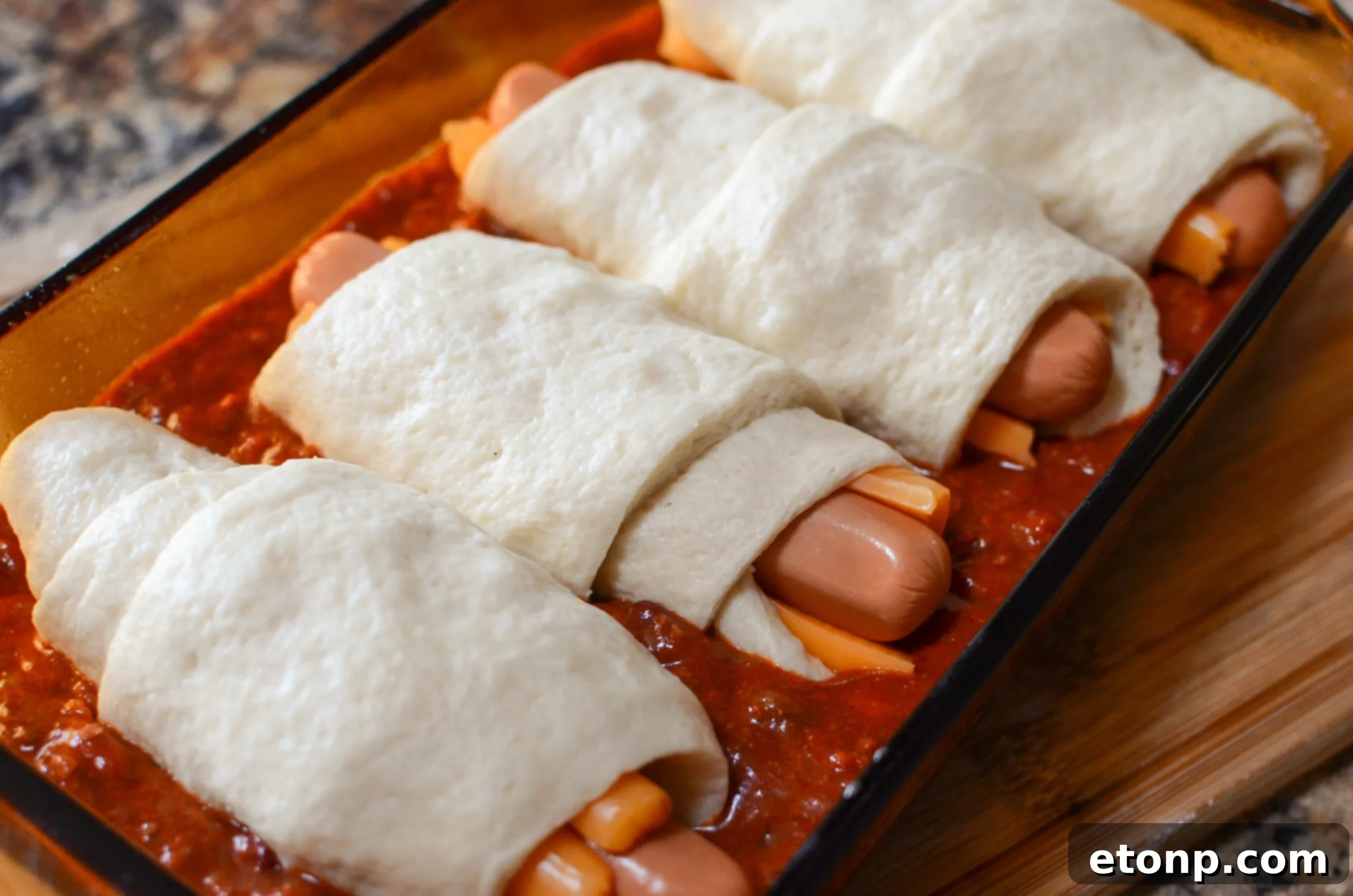 Chili cheese hot dogs in the baking pan