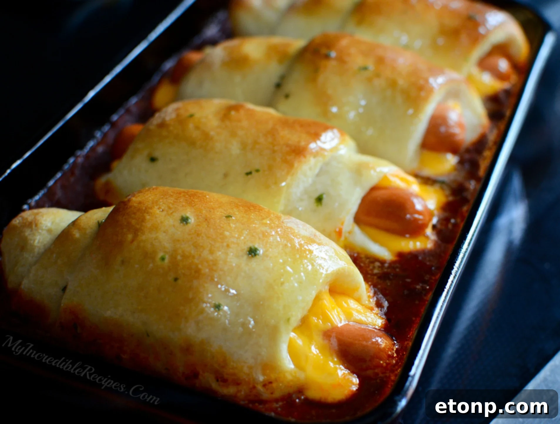 Close up of baked chili cheese dog with toppings