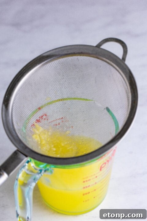 Close-up of fresh lemons being prepared for juicing.