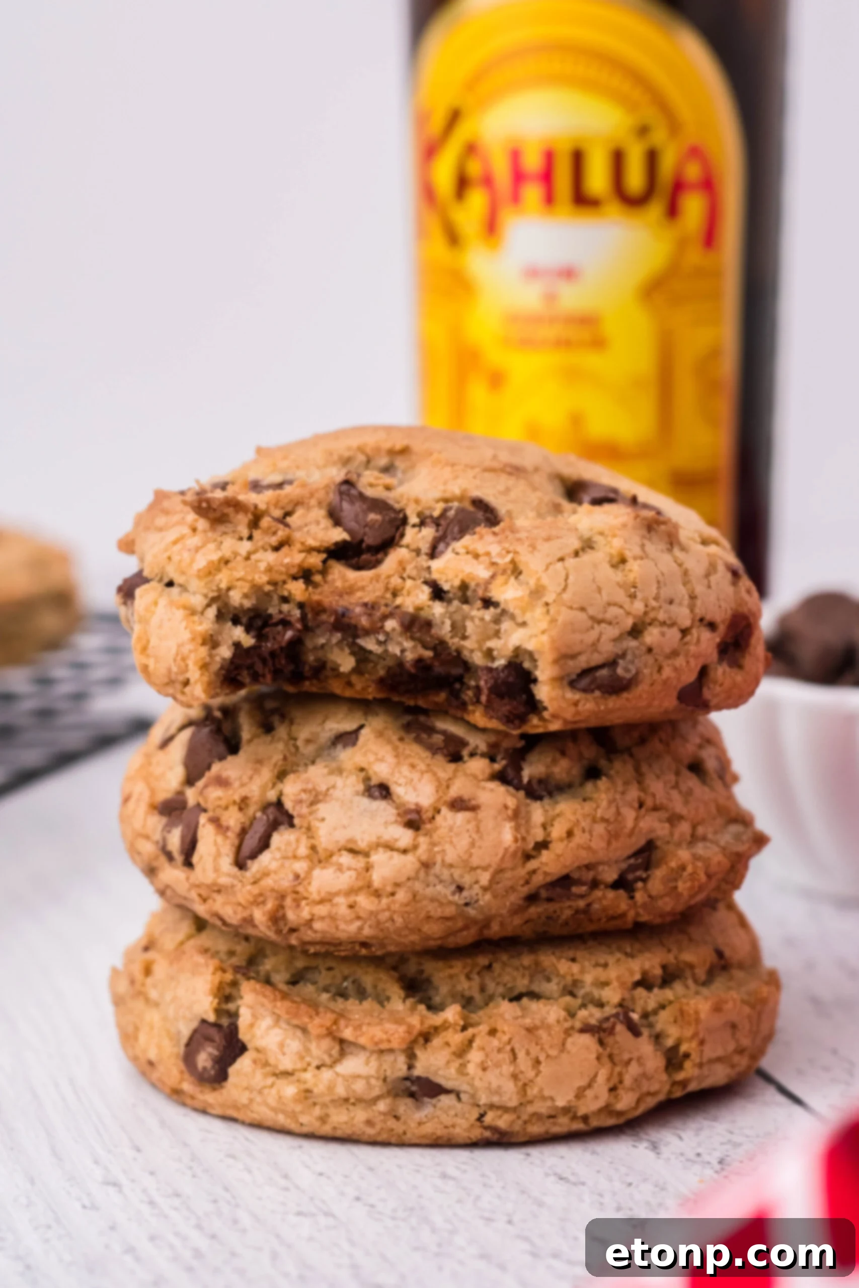 Front view of three Kahlua Cookies stacked with a bite removed from the top cookie.