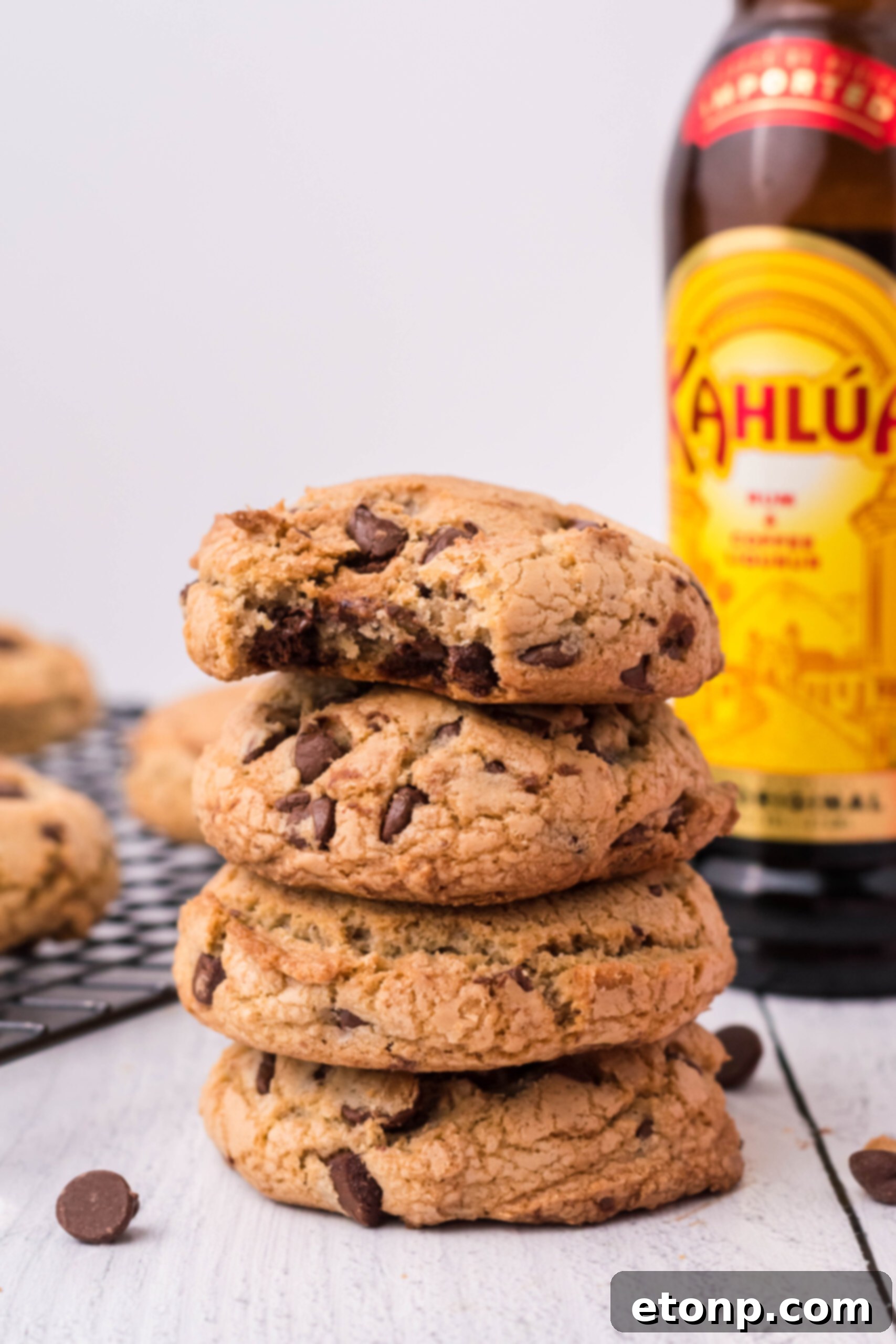 Front view of four Kahlua Cookies stacked with a bite removed from the top cookie.