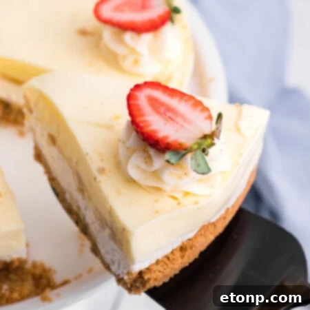 Close up view of a slice of Banana Cream Cheesecake on a black cake server.