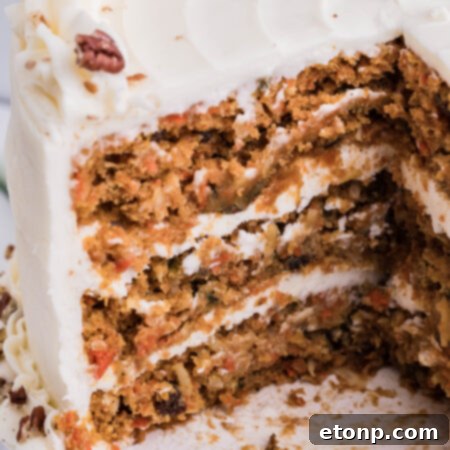 A vibrant carrot cake with creamy frosting, captured from a delicious angle.