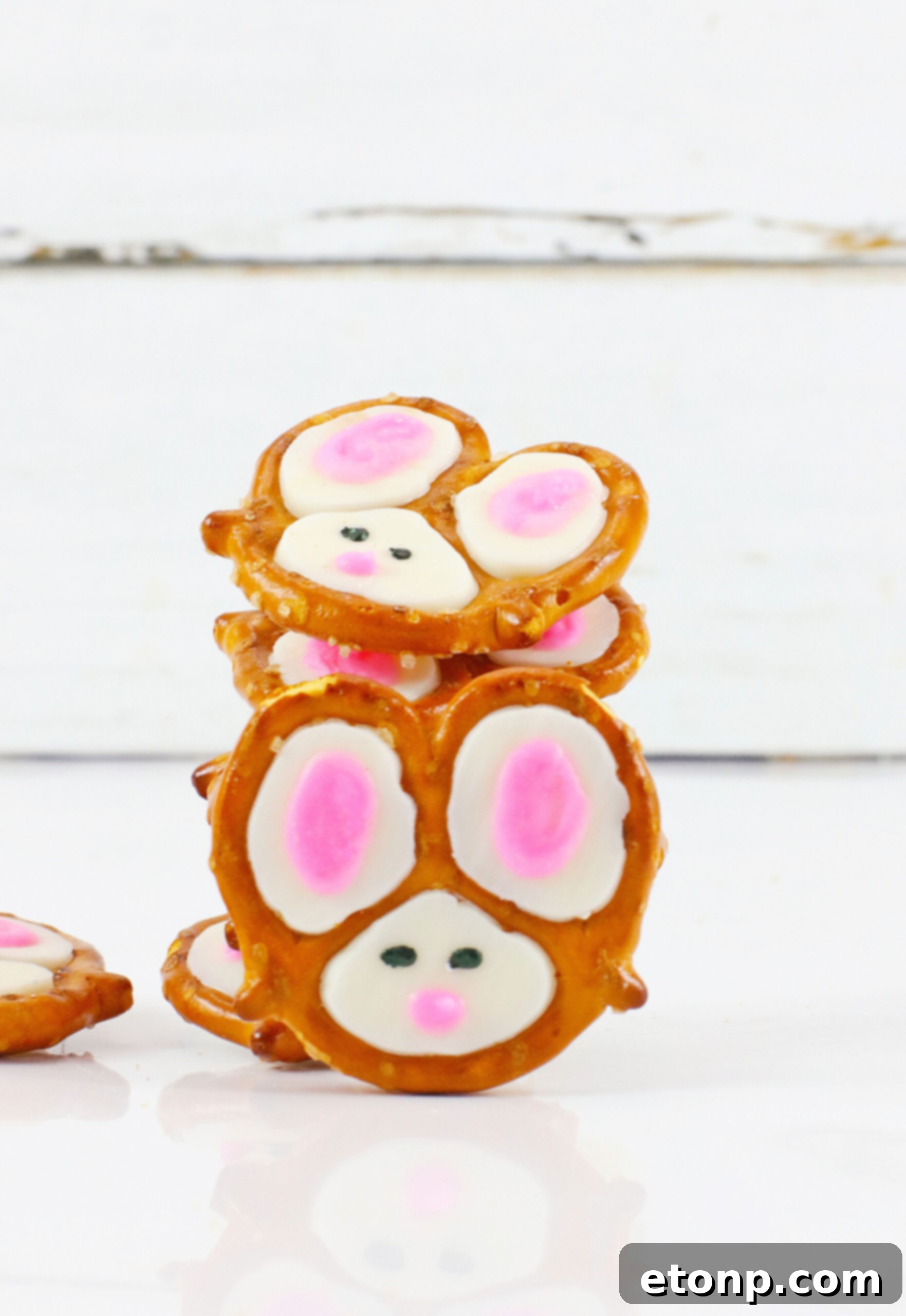 Front view of Bunny Pretzels stacked with one in front of the stack, ready to be picked up.