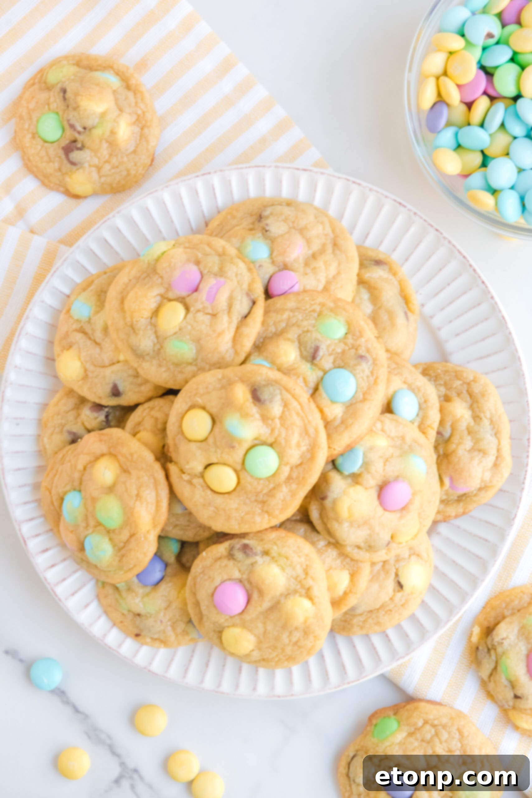 Overhead view of a stack of Easter Pudding Cookies on a white plate.