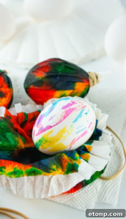 Finished tie dye Easter egg being unwrapped.