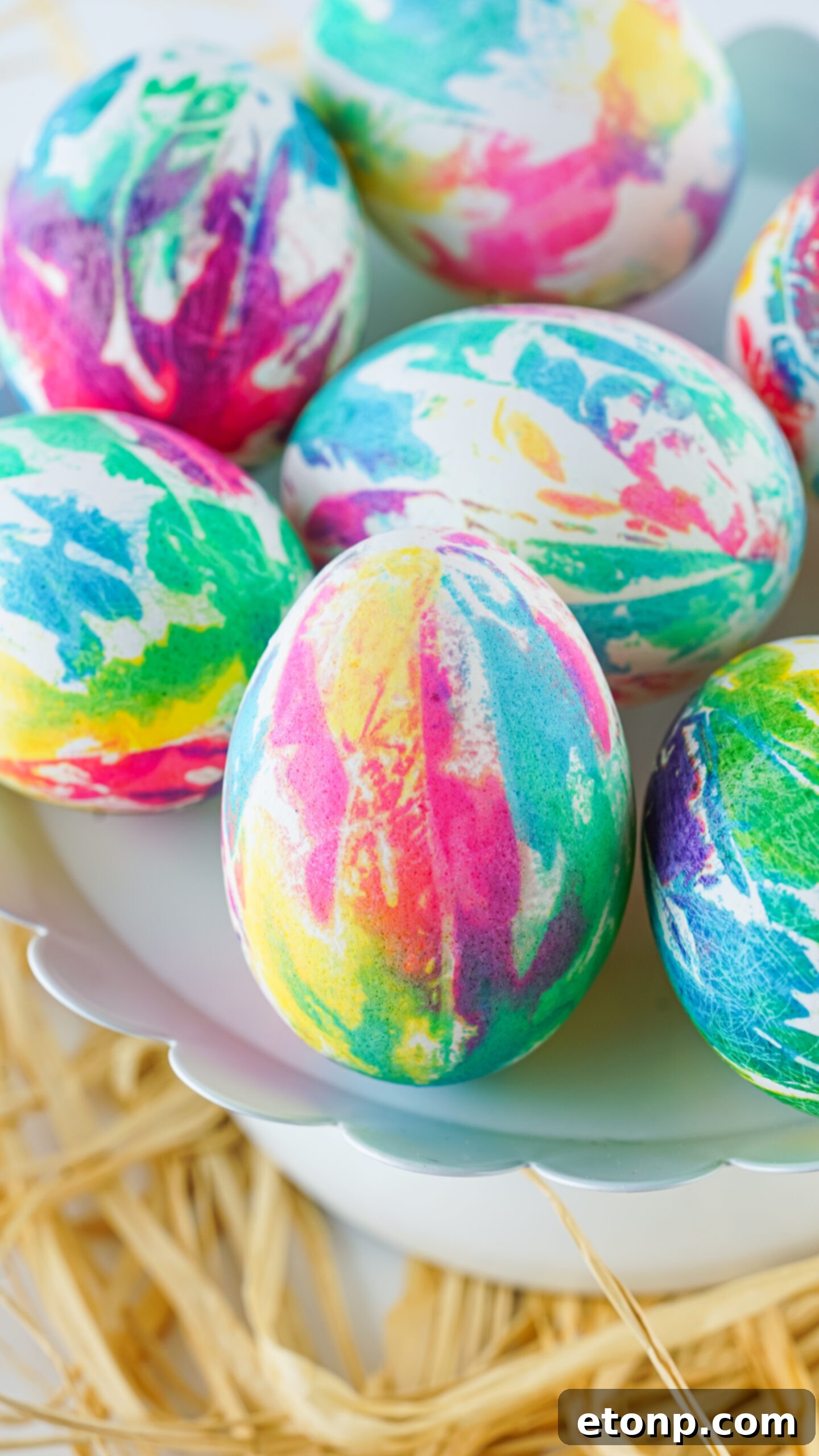 Close up view of Tie Dye Easter Eggs on a white stand.