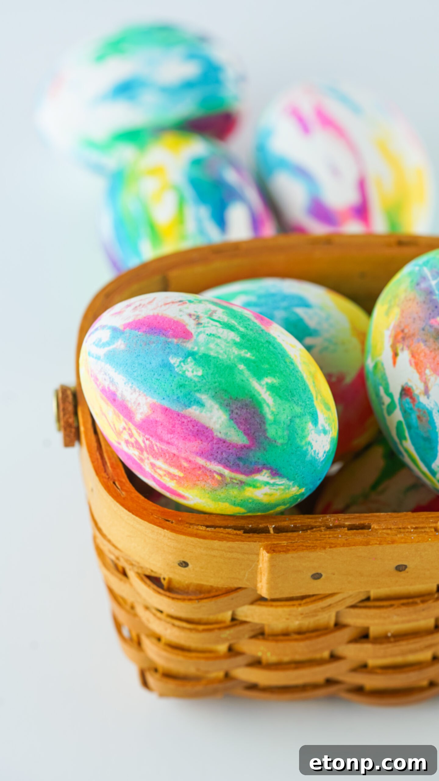 Close up view of Tie Dye Easter Eggs in a brown basket.