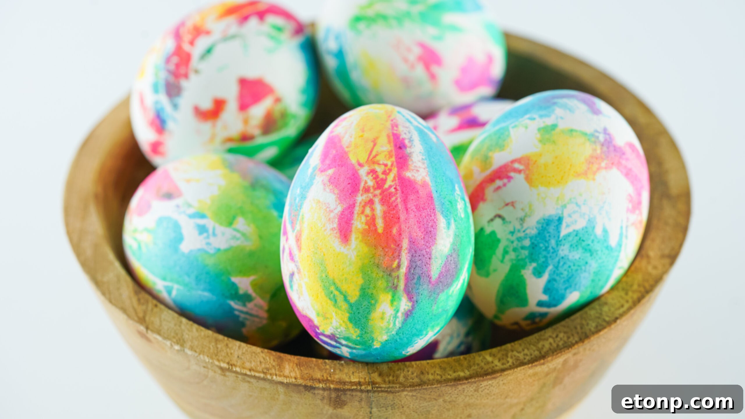 Front view of Tie Dye Easter Eggs in a brown bowl.