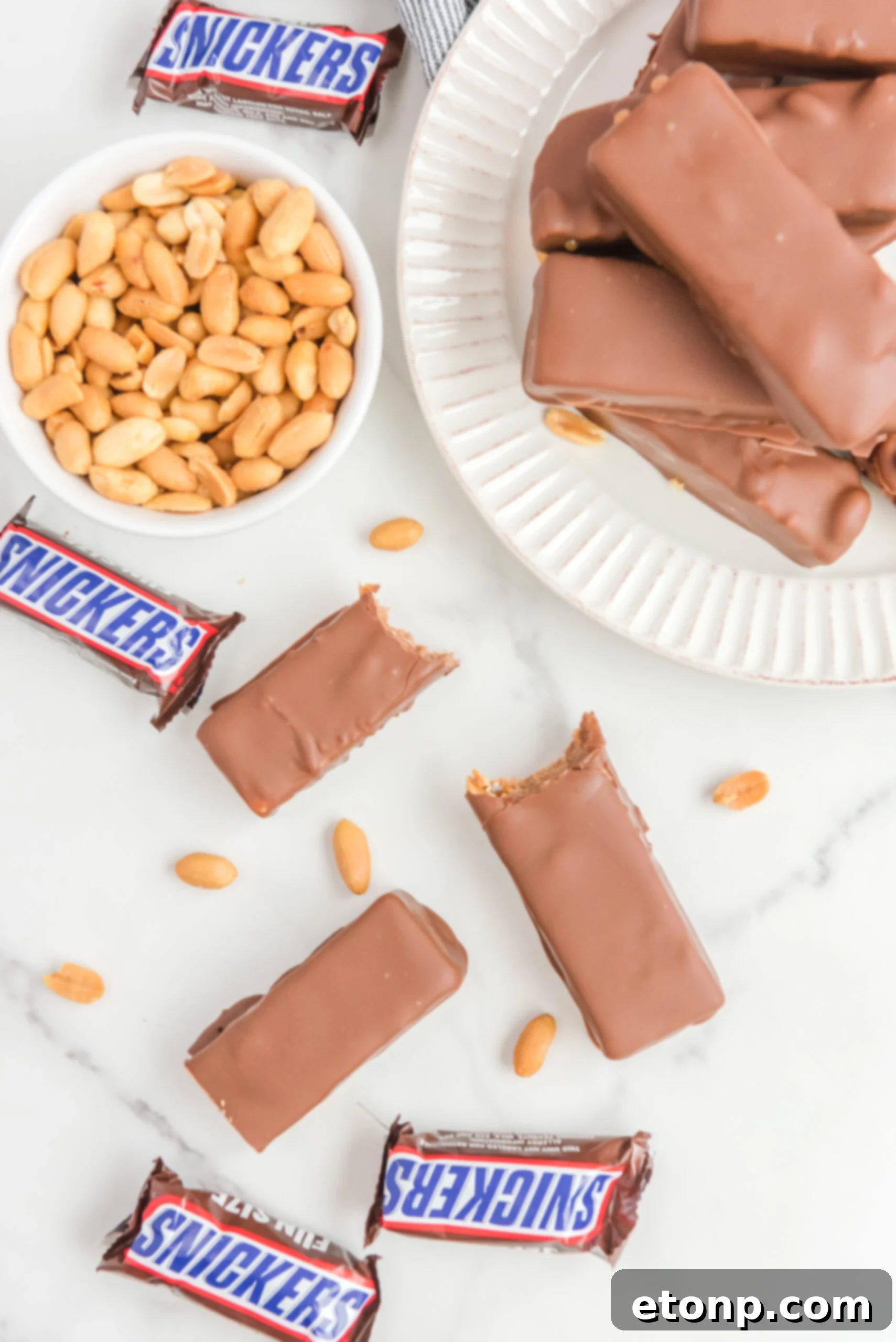 Overhead view of Homemade Snickers Bars with bites removed from two bars.