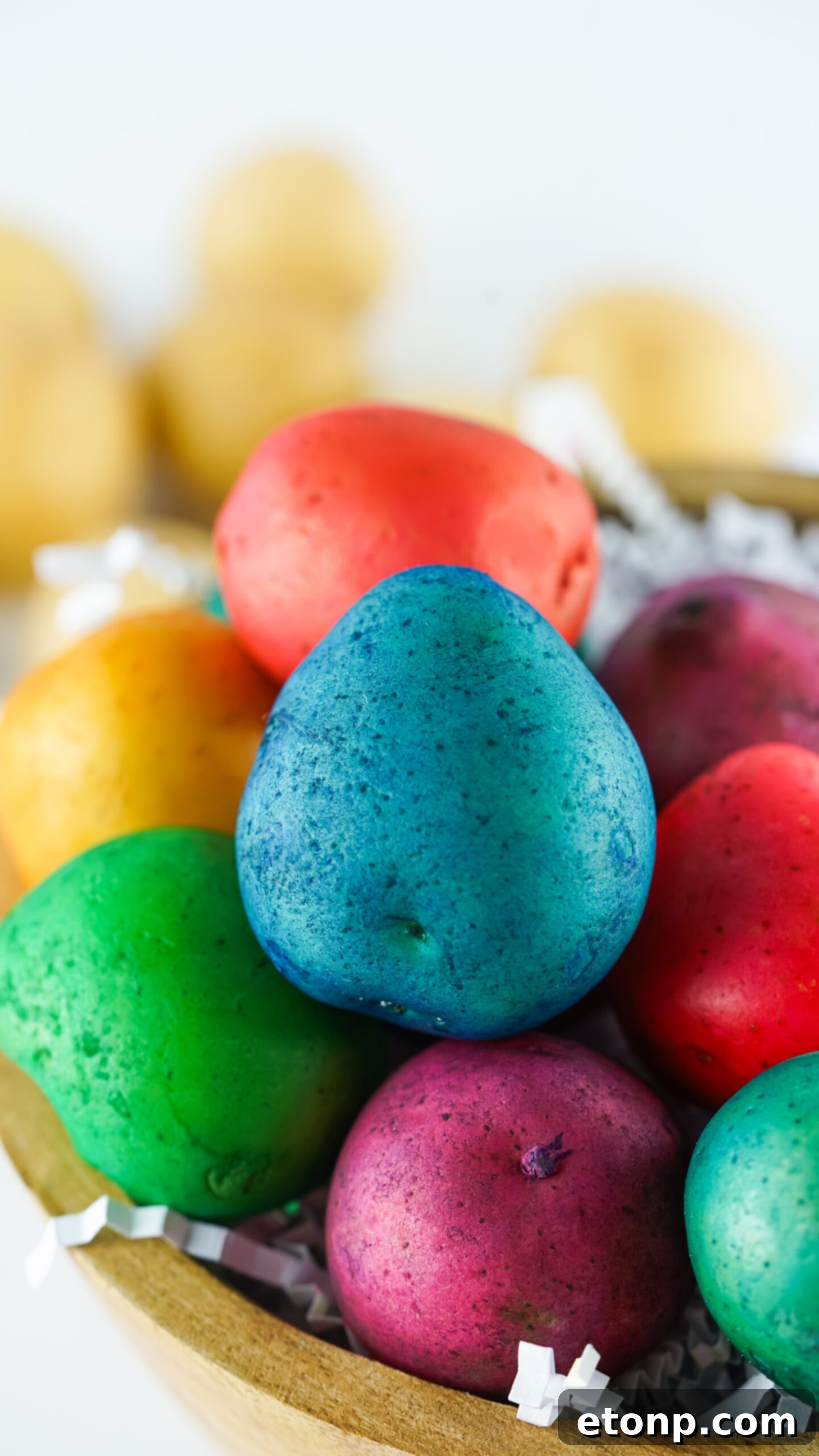 Close-up view of the Dyed Easter Egg Potatoes in the brown bowl, highlighting their vibrant colors and unique appeal.