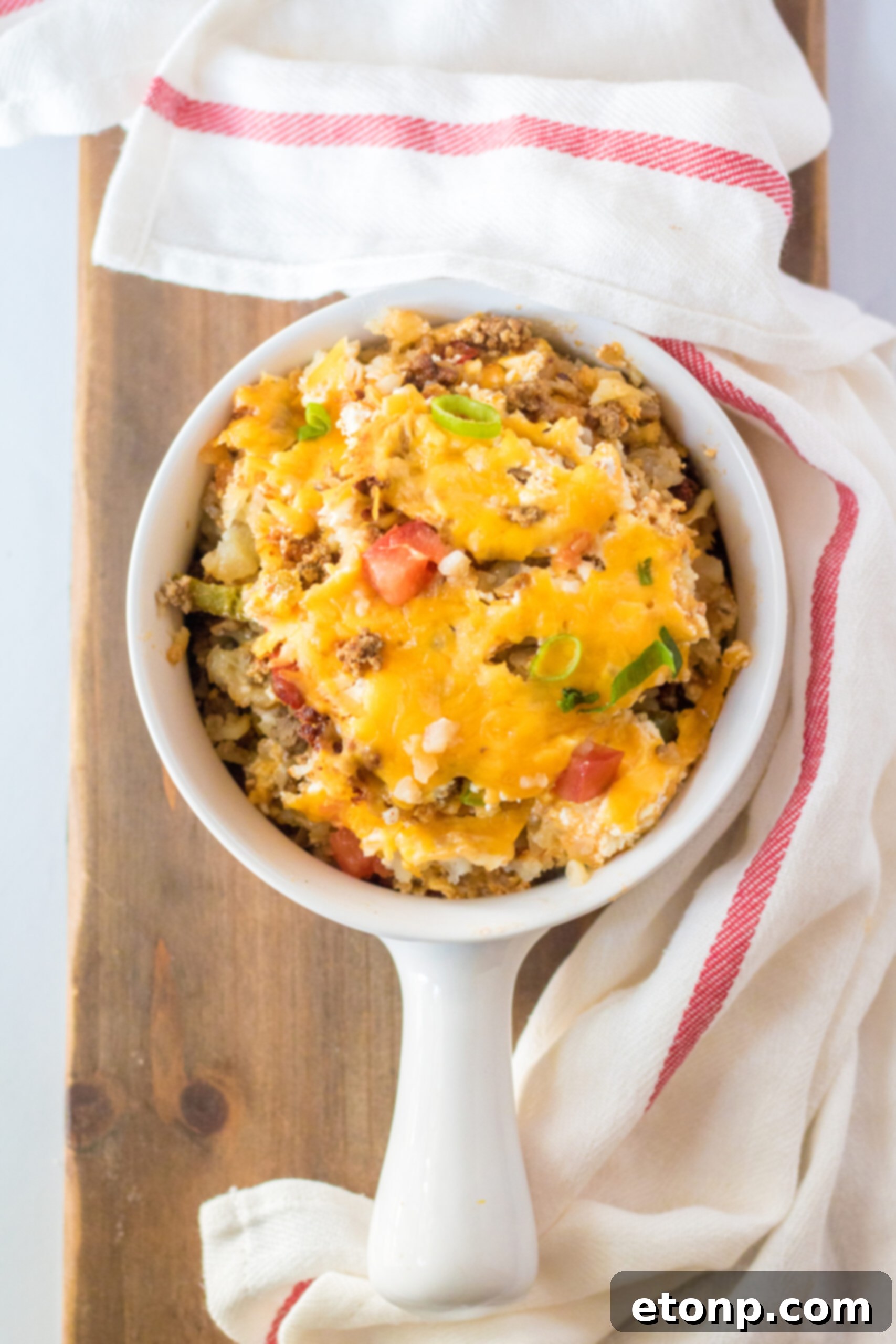 Overhead view of a serving of Slow Cooker John Wayne Casserole in a white bowl.