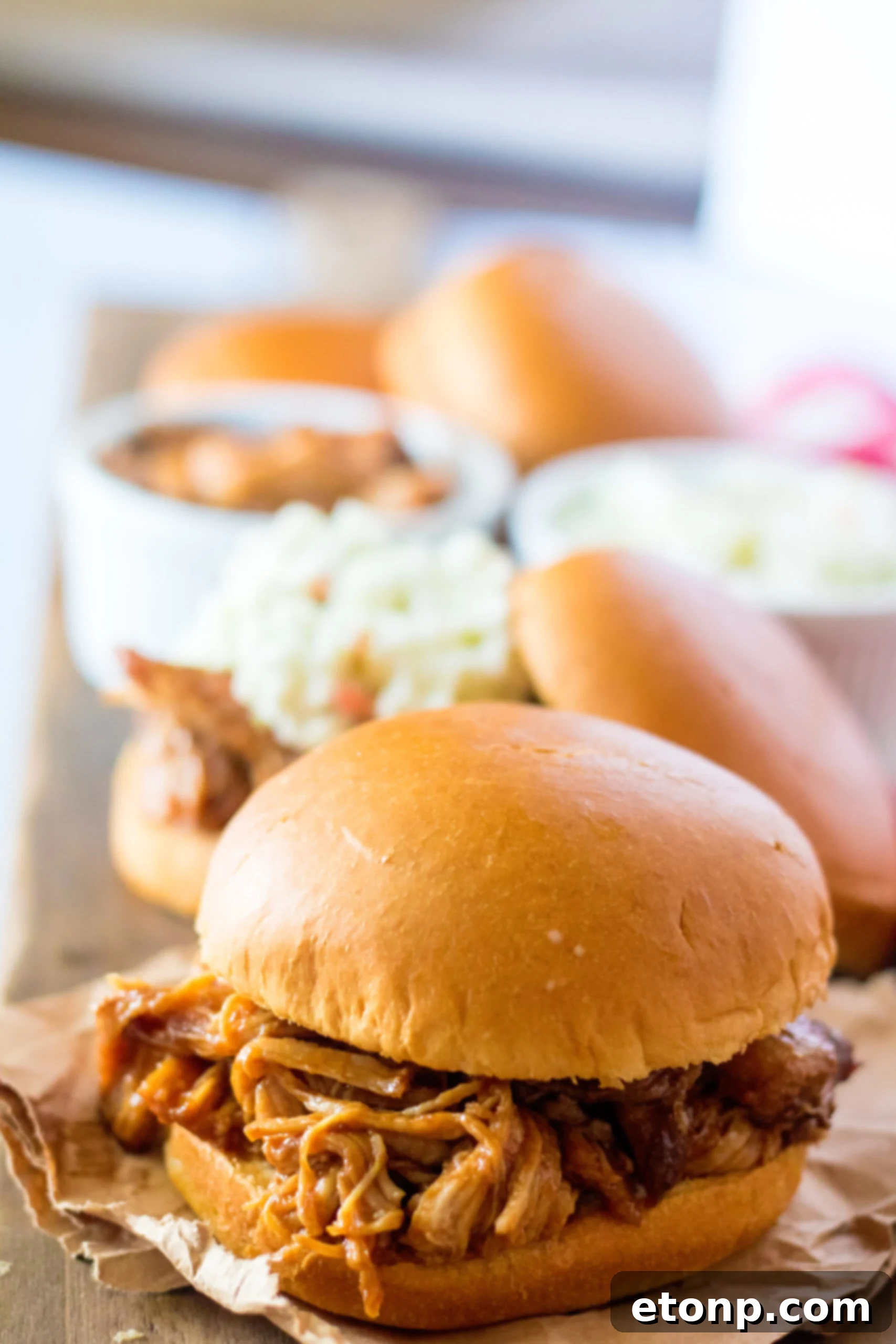 Front view of Slow Cooker Cola Pulled Pork on a bun.