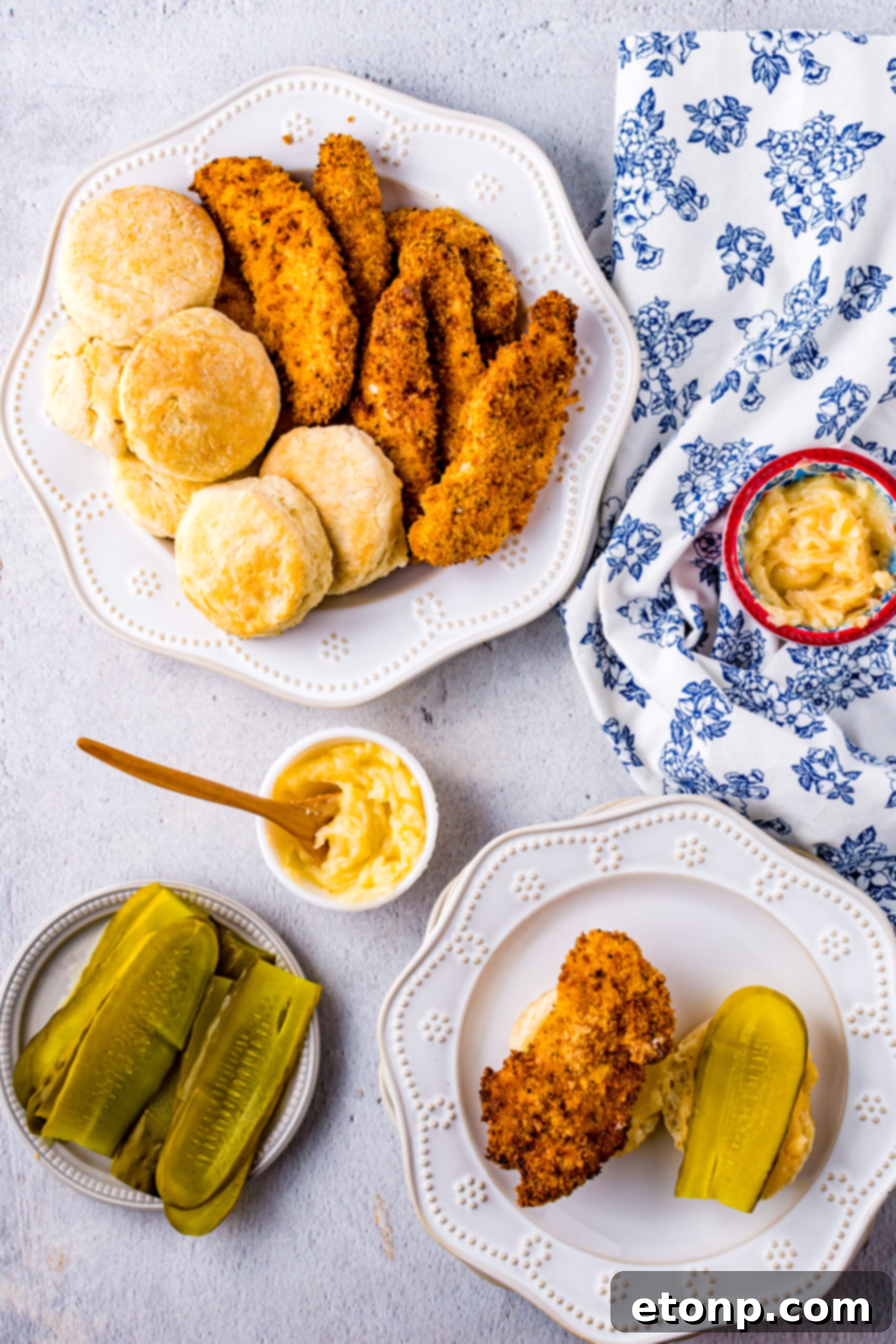 Overhead view of an unassembled Honey Butter Chicken Biscuit, showing the golden-brown chicken and fluffy biscuit on a white dish.