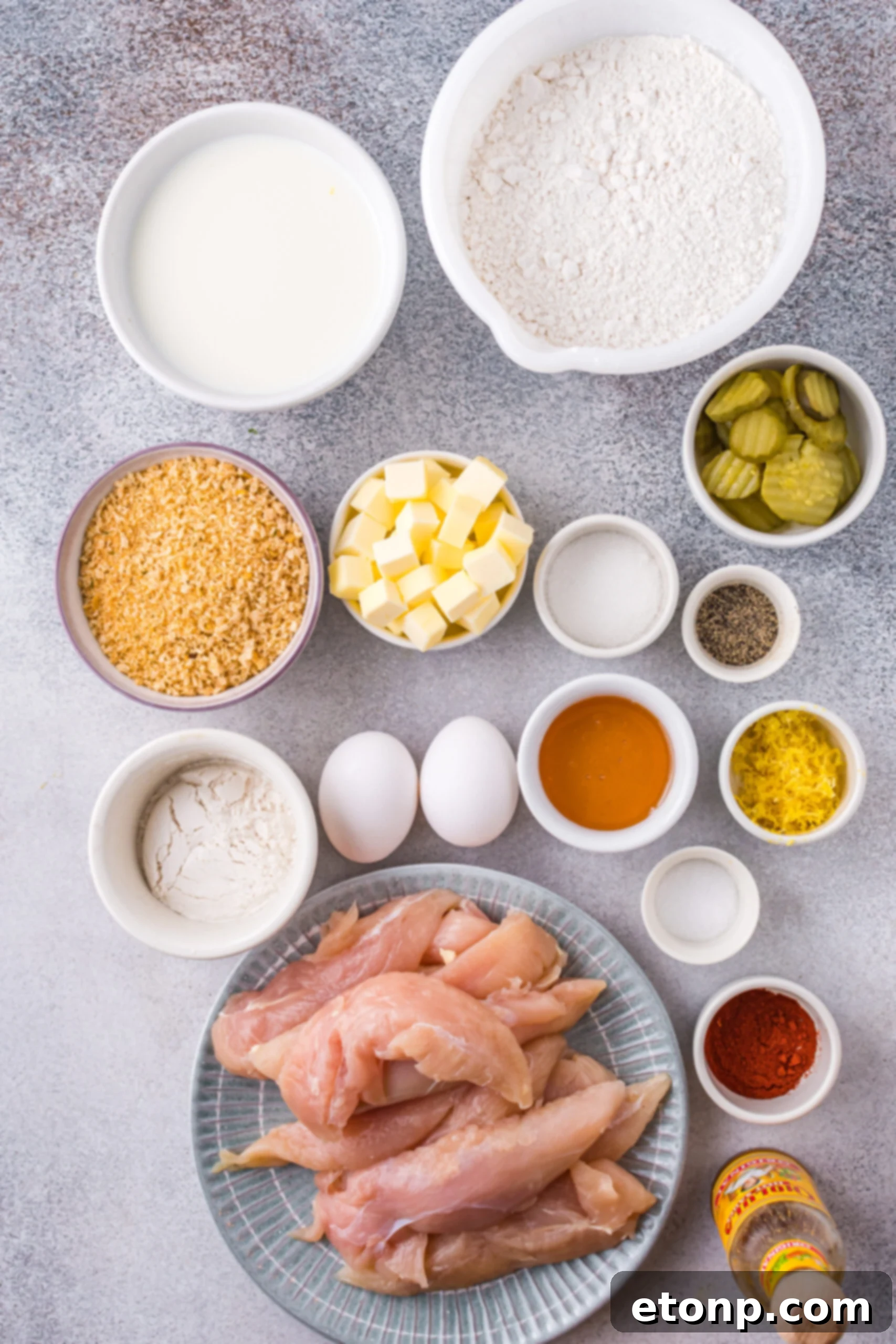Overhead view of all the fresh ingredients laid out for preparing the Honey Butter Chicken Biscuit recipe on a wooden surface.