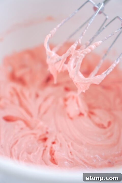 Strawberry brownie batter spread in a baking dish.