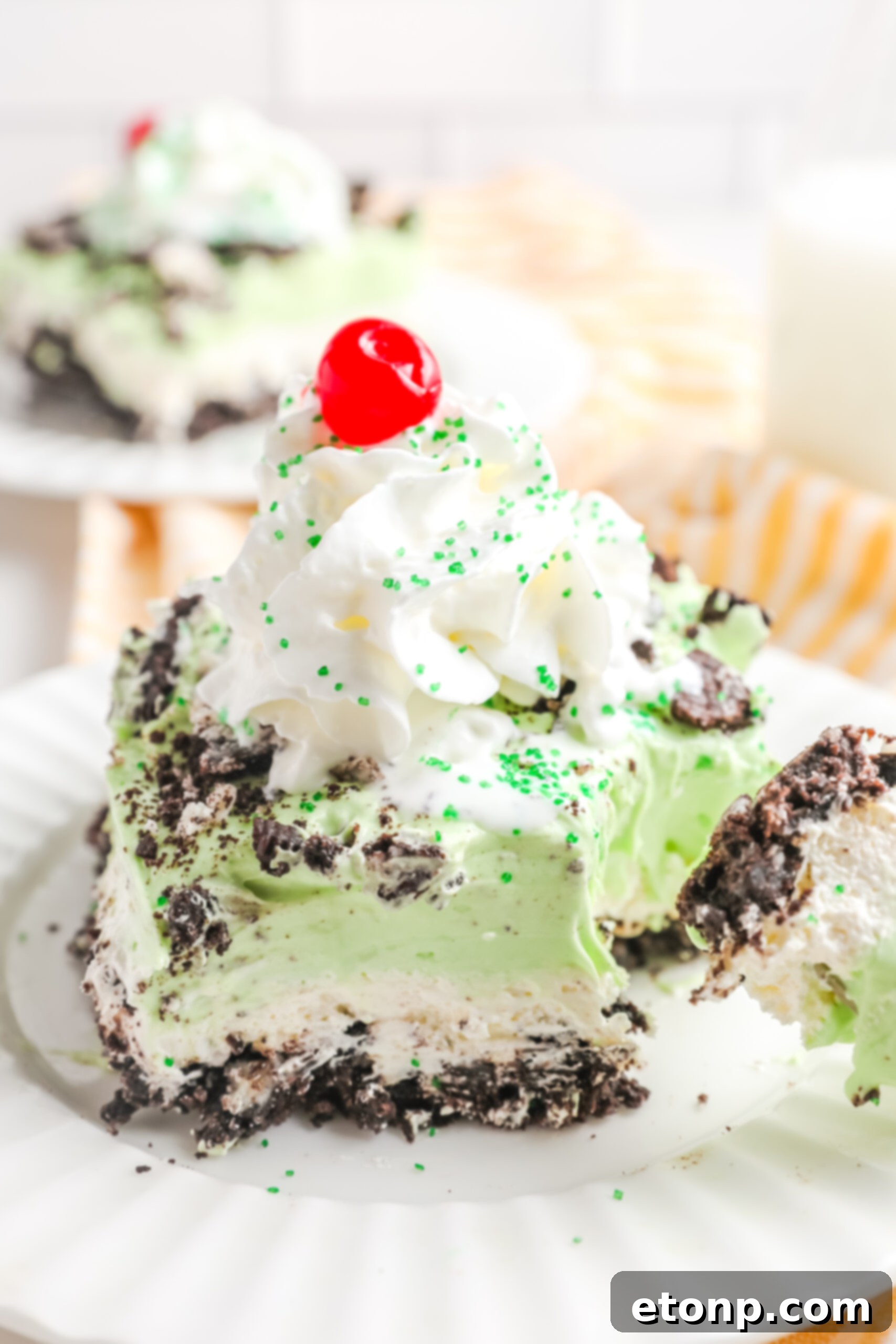 A close-up view of a tantalizing bite being taken from a piece of Shamrock Lasagna, highlighting the delectable creamy layers within.
