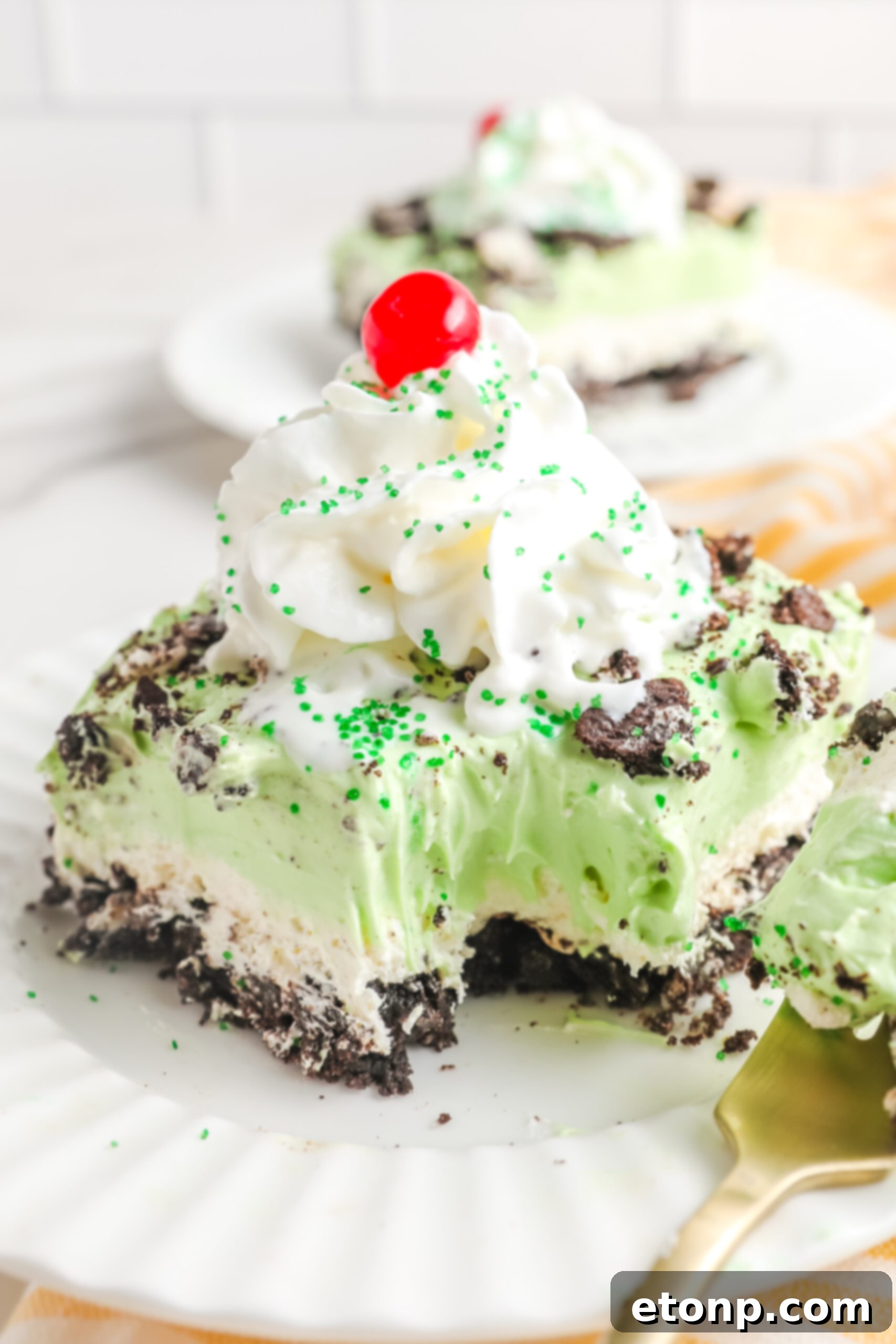 An intimate close-up view of the Shamrock Lasagna, with a spoonful removed, beautifully showcasing its inviting creamy layers and delicious texture.