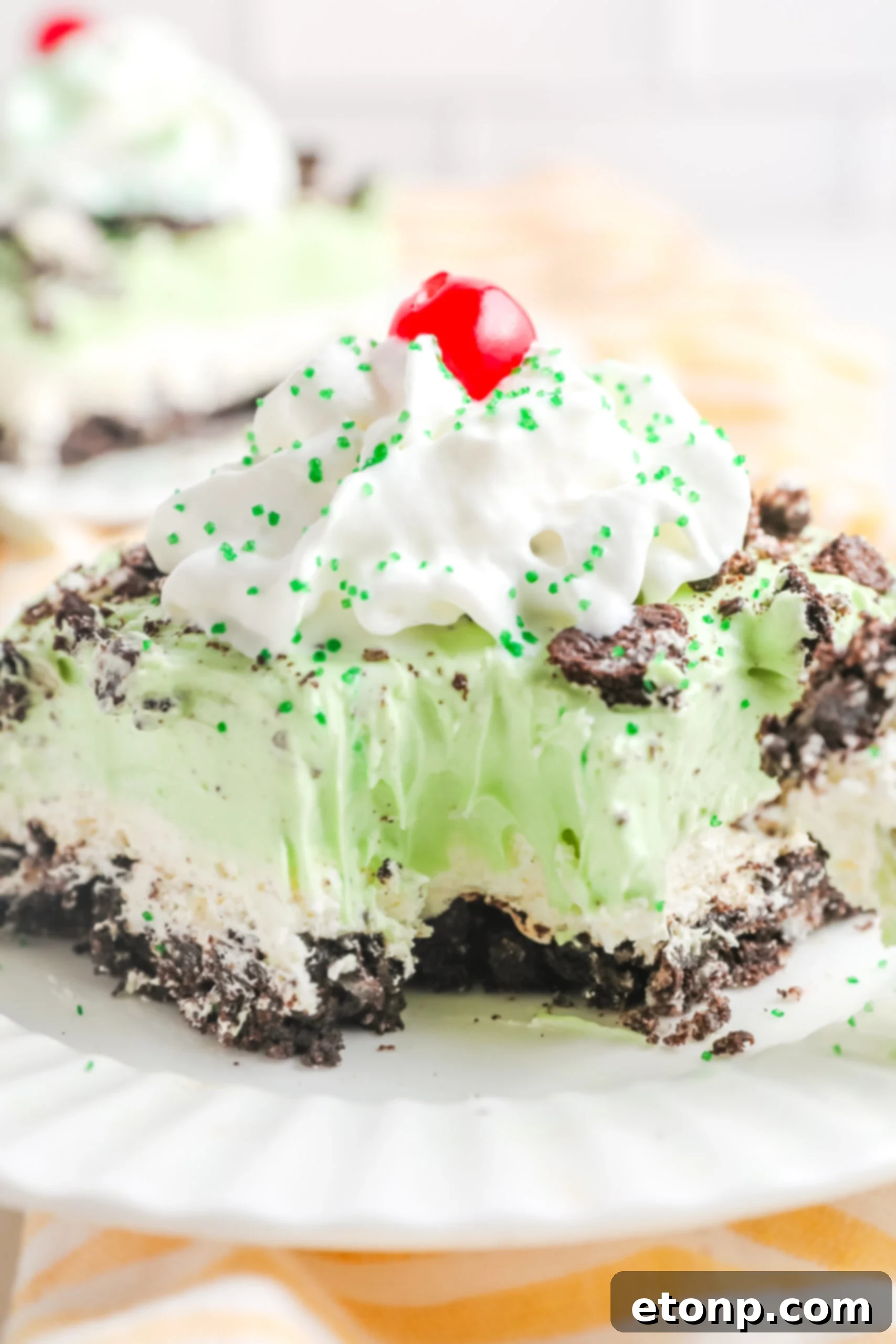 An enticing up-close view of a single bite being removed from a slice of Shamrock Lasagna, showcasing its perfect layers and inviting texture.