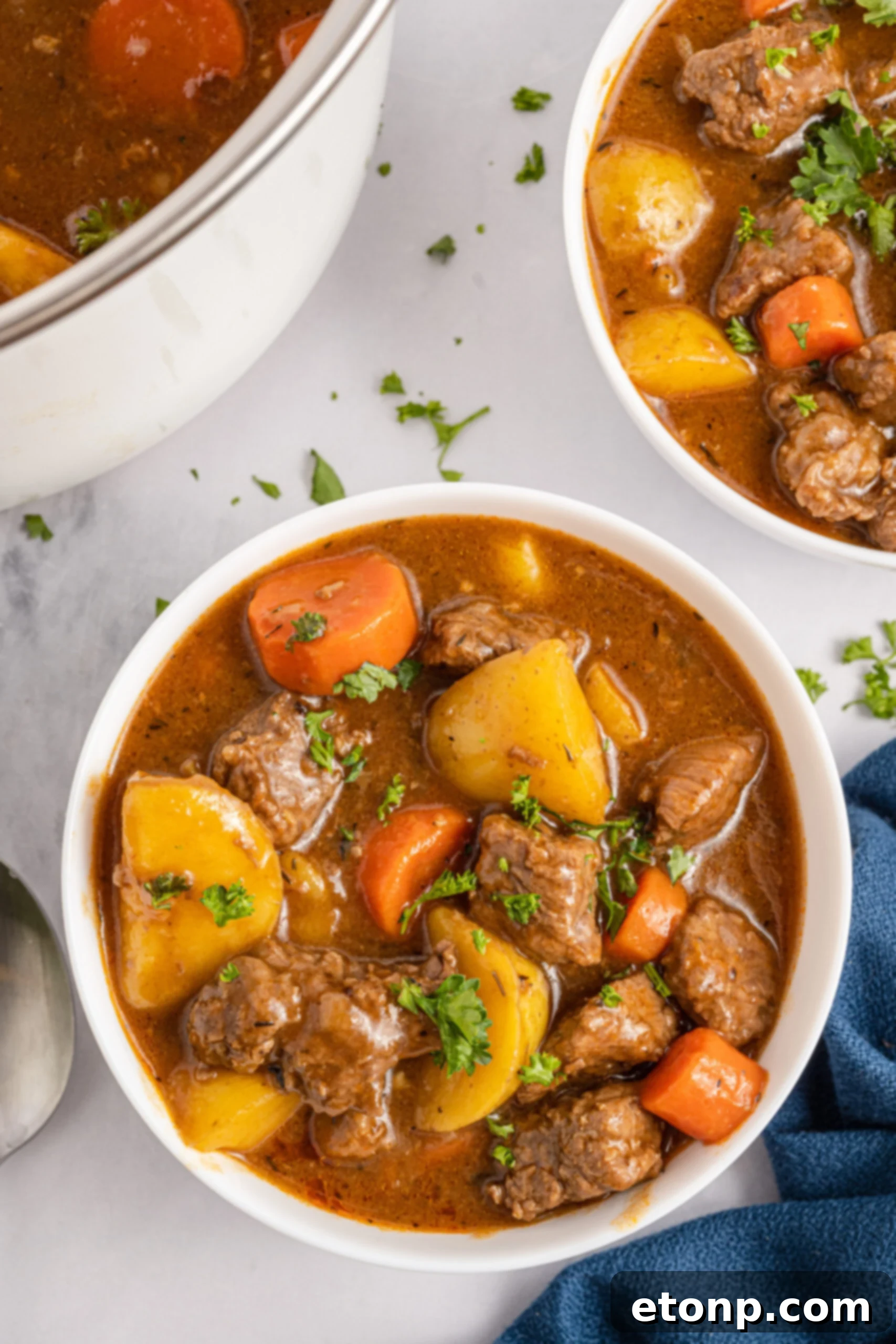 Irish Stew in a white bowl with a blue linen. 