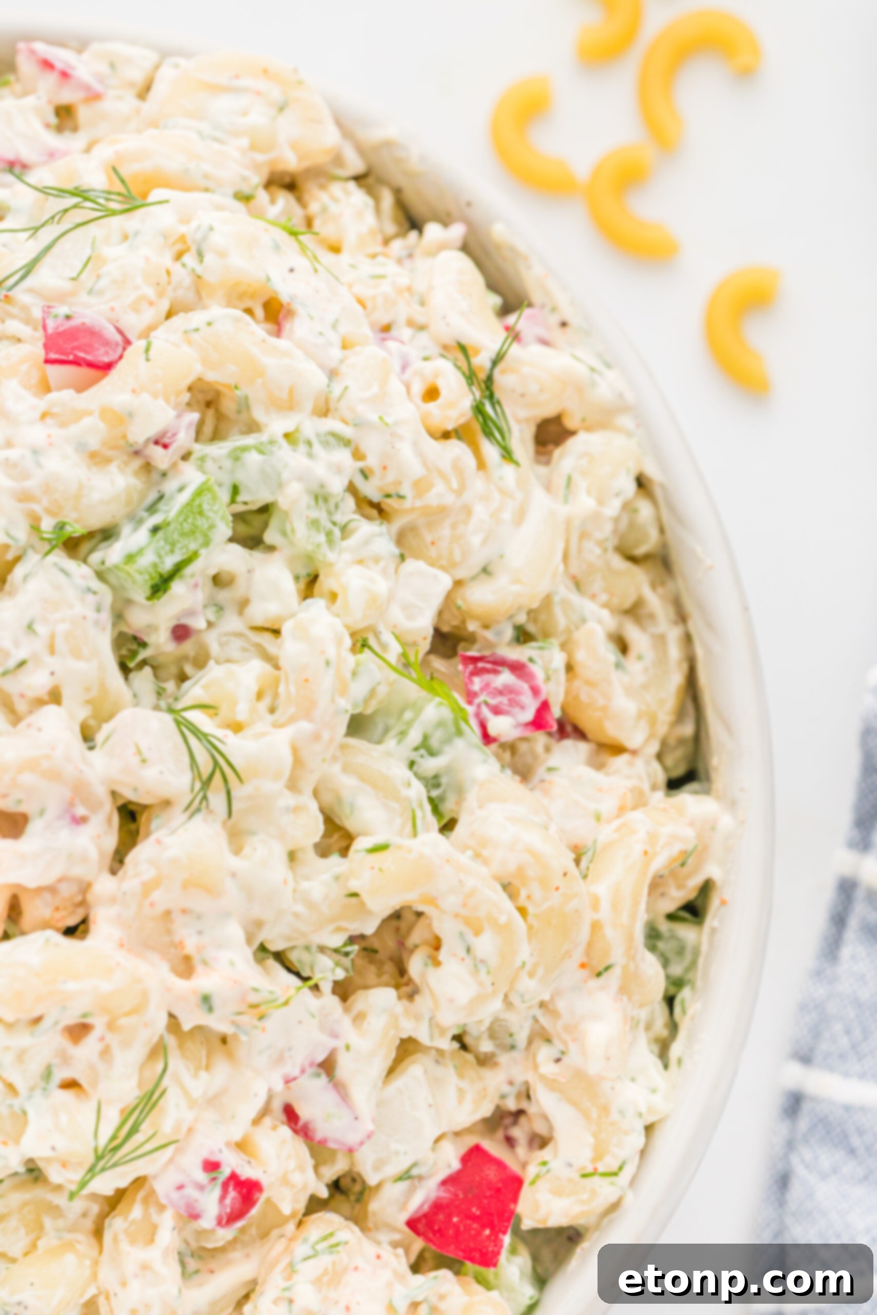 Creamy Dill Macaroni Salad 10 Close up view of the enticing Macaroni Dill Pasta Salad, highlighting its texture and fresh ingredients.