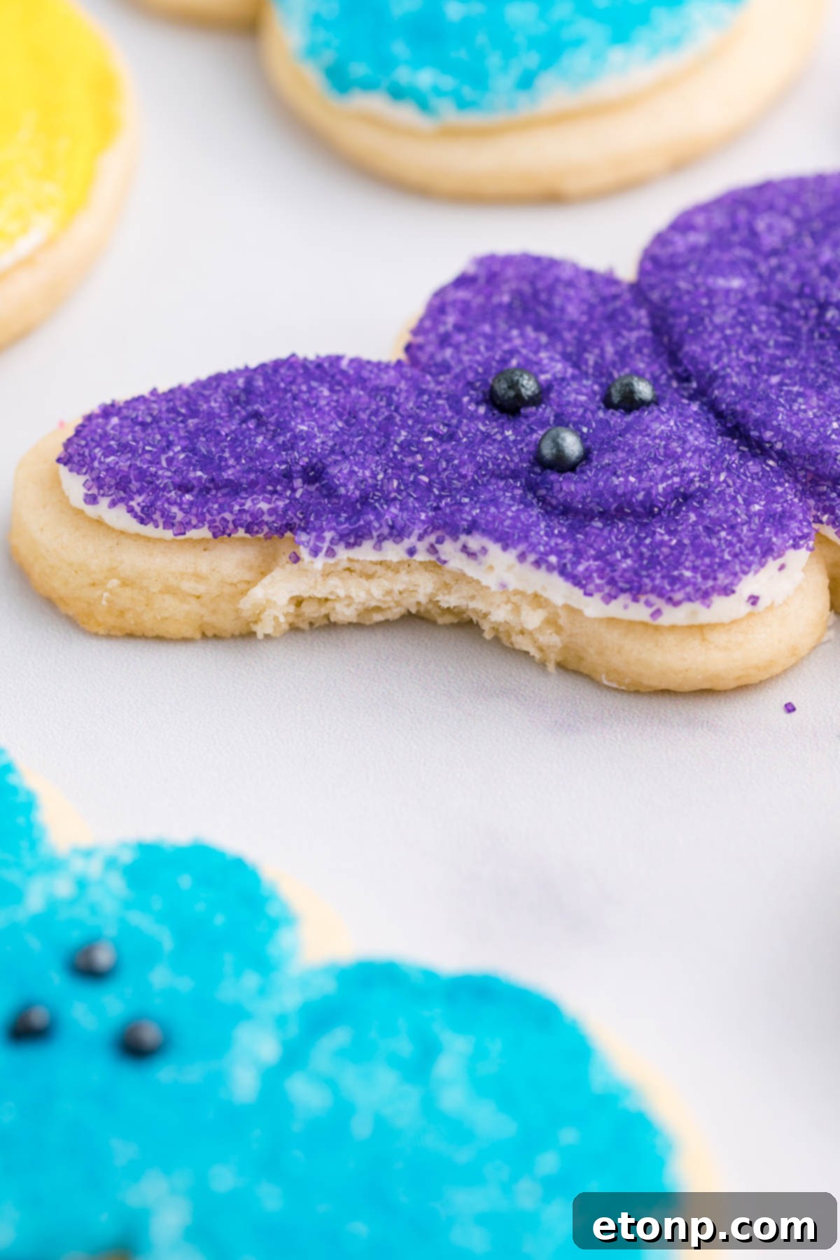 A purple Bunny Cookie with a bite taken out of the ear. 