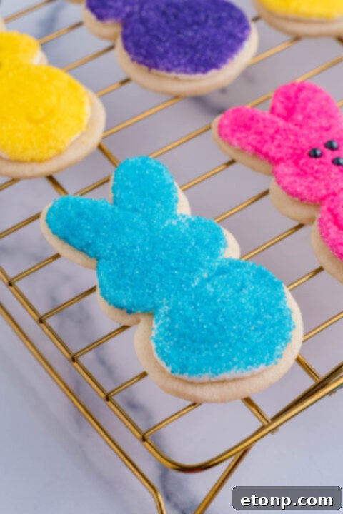 An Easter bunny cookie after being dipped in blue sprinkles. 