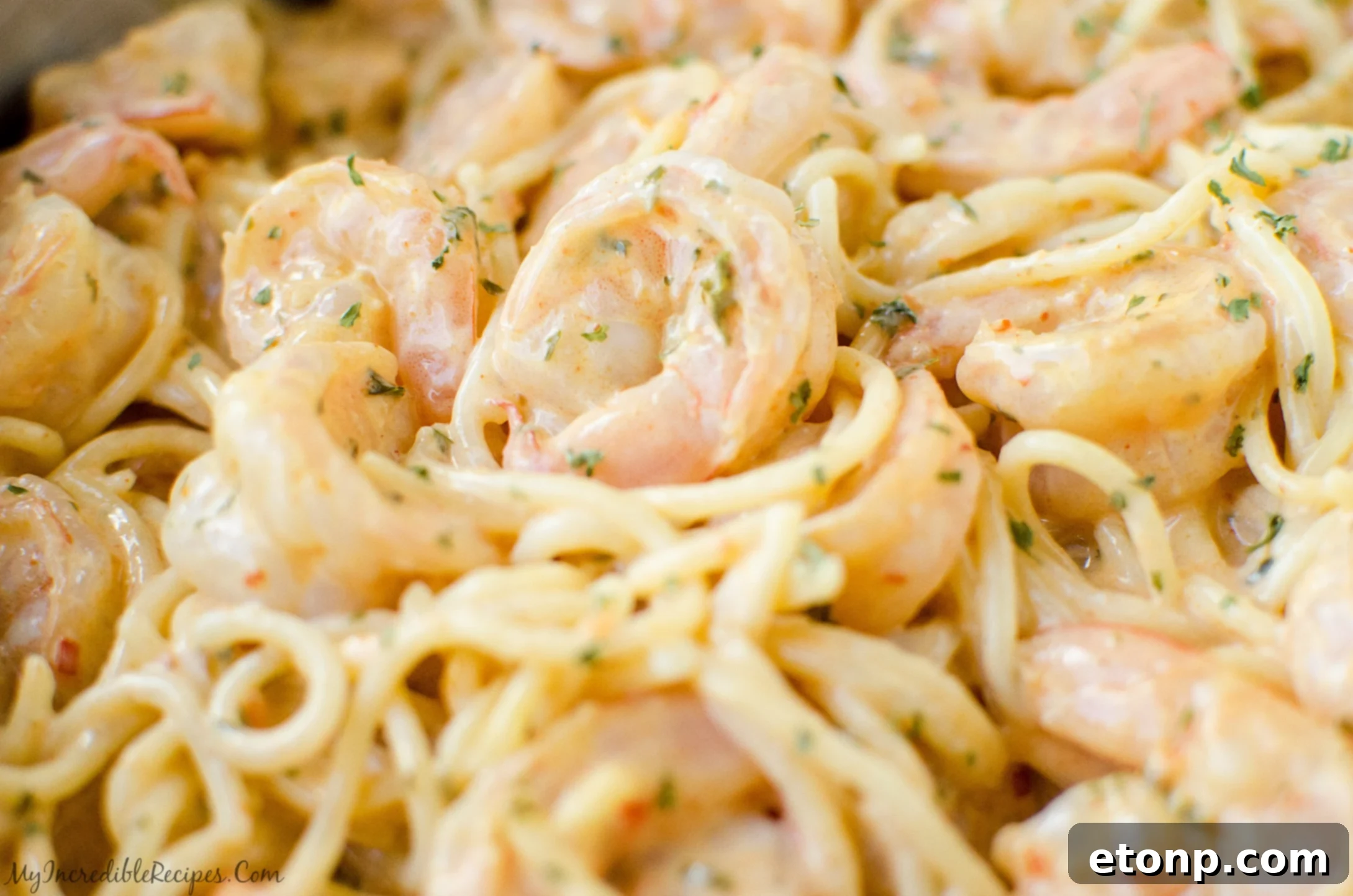 Close-up of perfectly cooked shrimp coated in Bang Bang sauce.